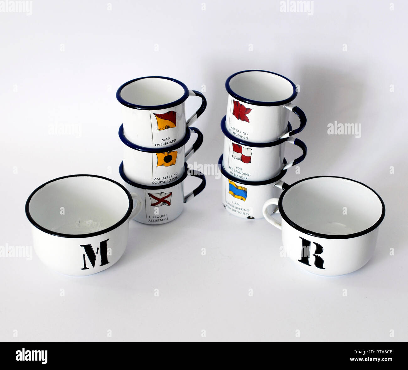 Set of enameled metal cups, with nautical motifs Stock Photo