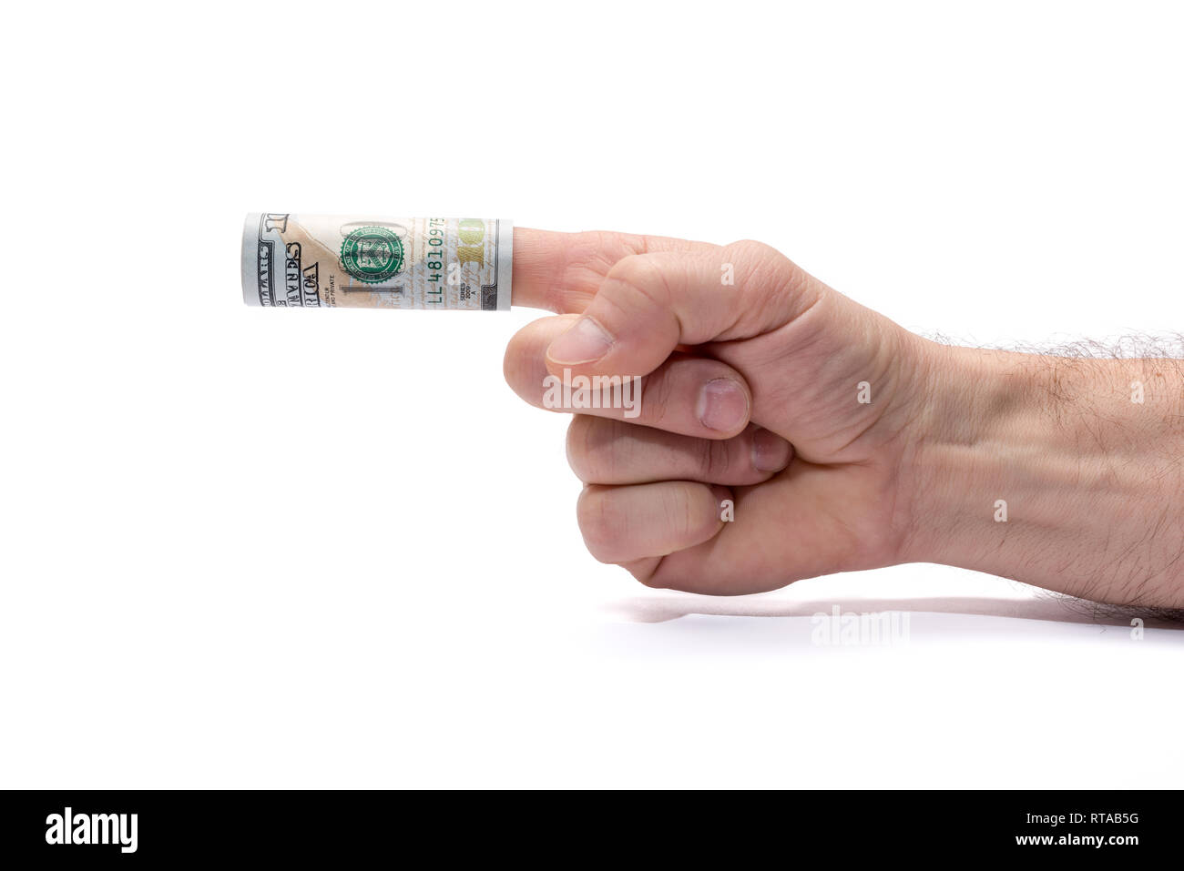 Conceptual image of don't or accepting bribes. Hand pointing left, a hundred dollar banknote wrapped around his finger. Are you offered a bribe? Stock Photo