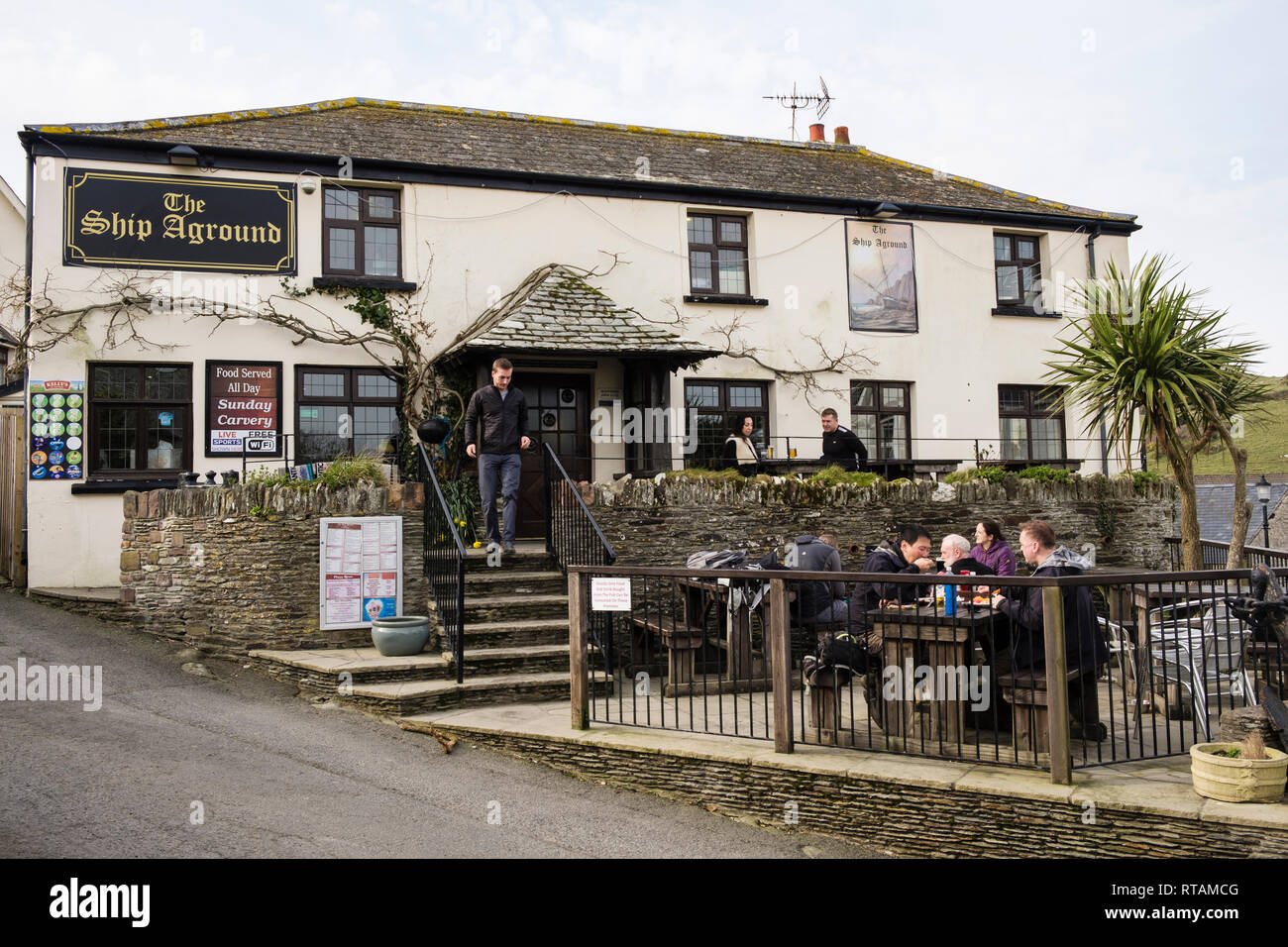 The Ship Aground village pub with people dining outside in Mortehoe, North Devon, England, UK, Britain Stock Photo