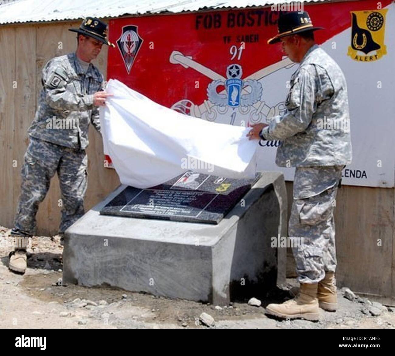 Members of the 173rd Airborne Brigade unveil a plaque and officially name Froward Operating Base Bostick in honor of Maj. Thomas G. Bostick, killed in action in 2007 while commanding Bulldog Troop, 1st Squadron, 91st Cavalry Regt. Stock Photo