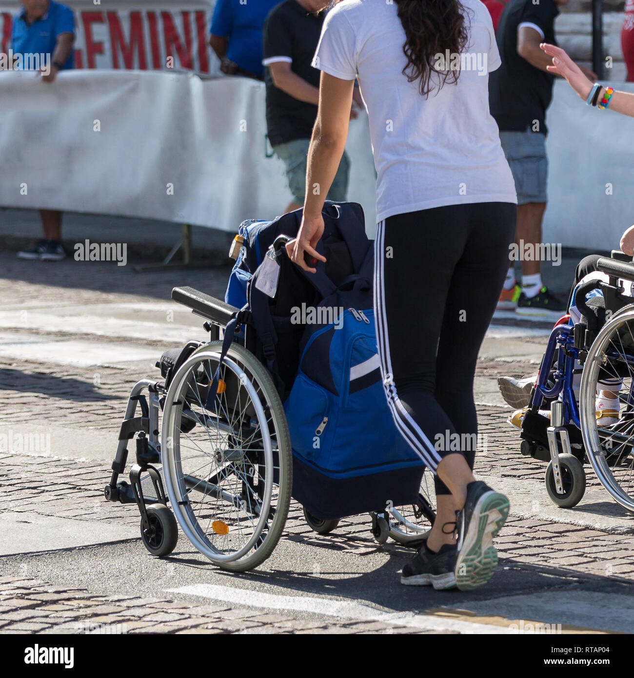 Girl Pushing Wheelchair High Resolution Stock Photography and Images
