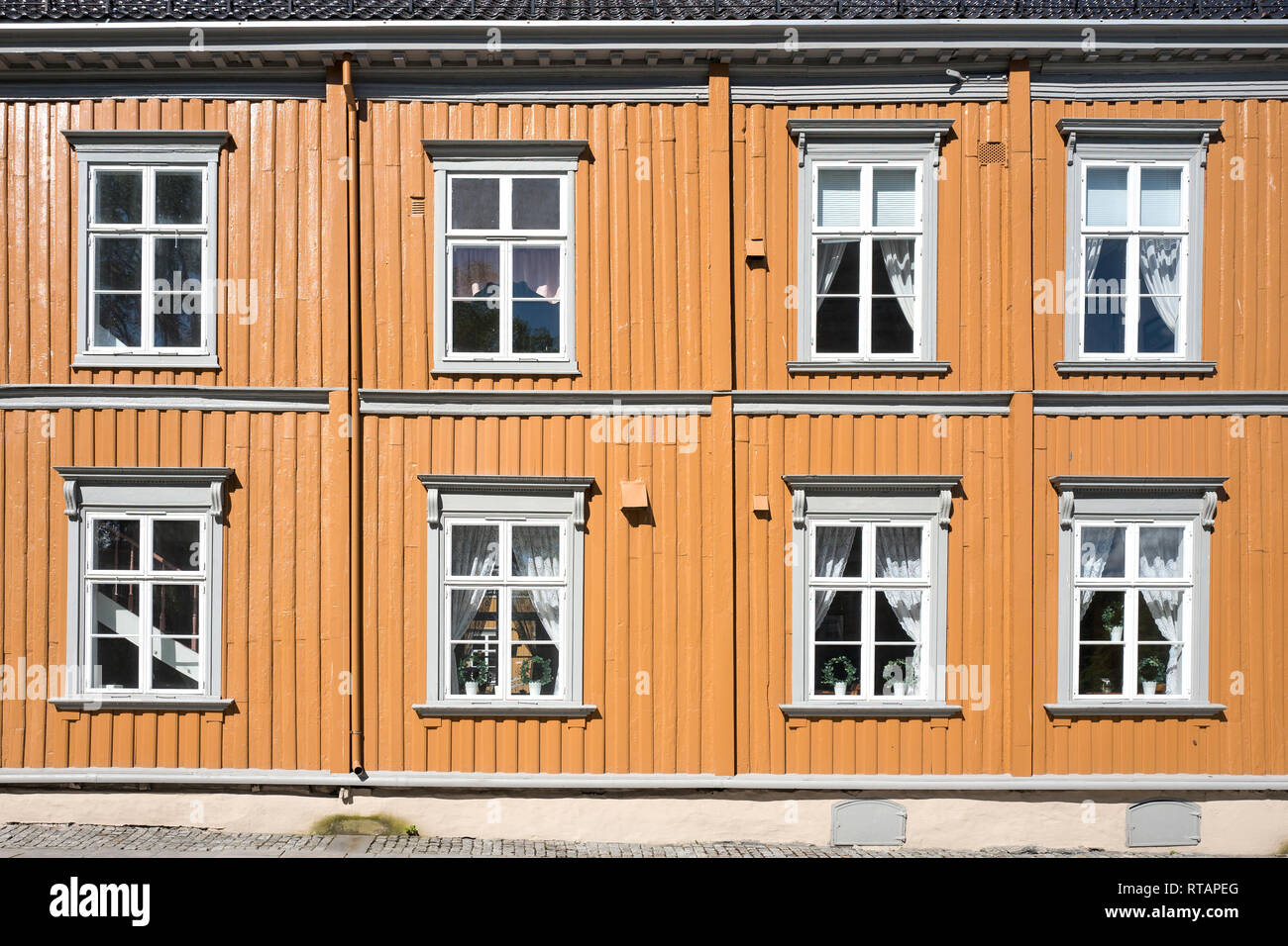 facade of a typical yellow colored Norwegian wooden house Stock Photo