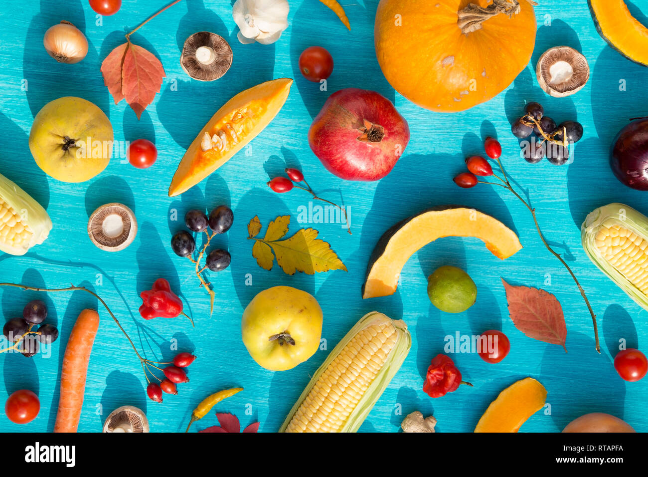 Various fresh fruits and vegetables on blue background Stock Photo - Alamy
