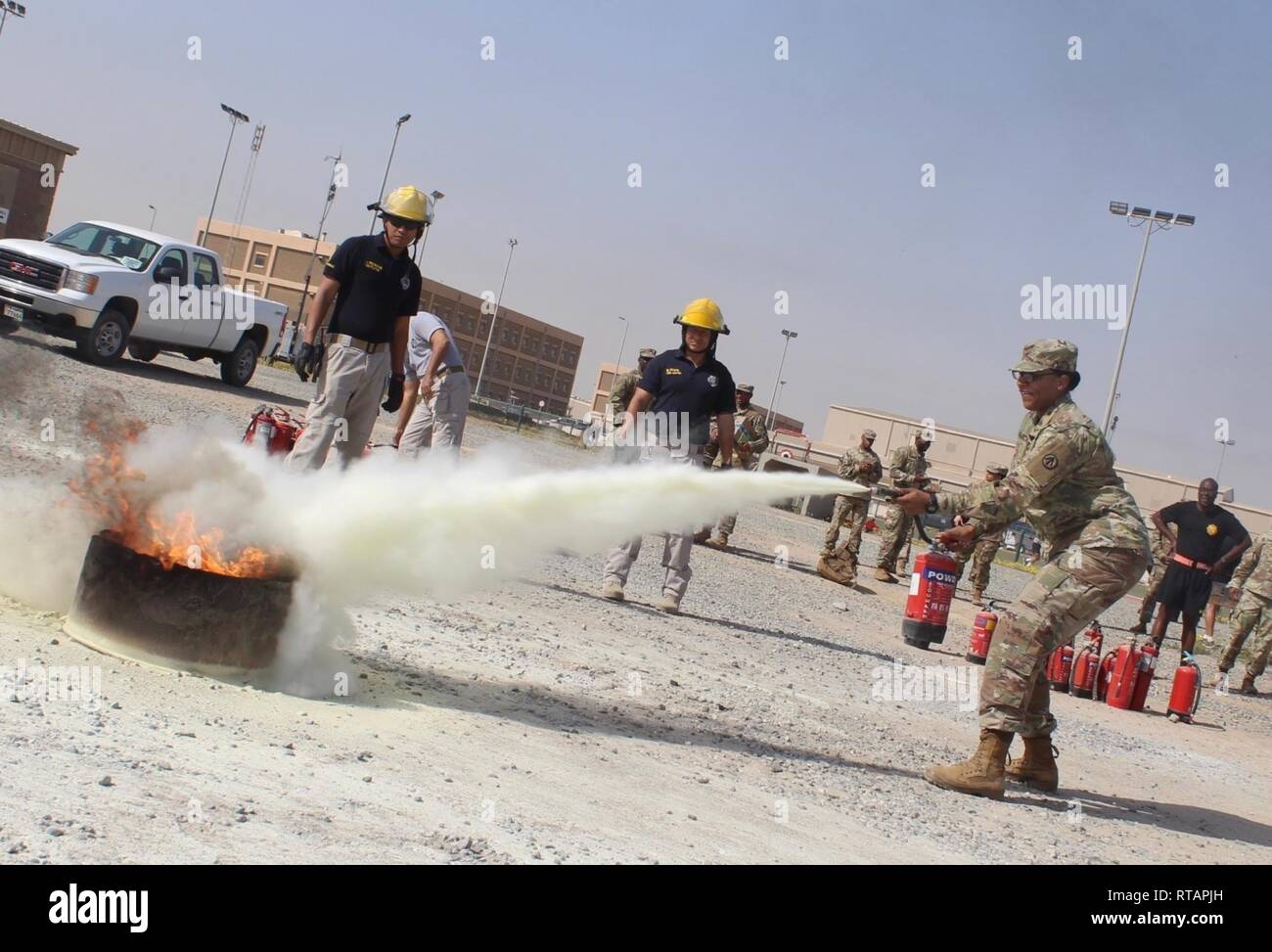 Sgt. Chantay N. Webster, 840th Transportation Battalion, approaches and extinguishes a controlled flame during safety training at Camp Arifjan, Kuwait, Feb. 1, 2019. Stock Photo