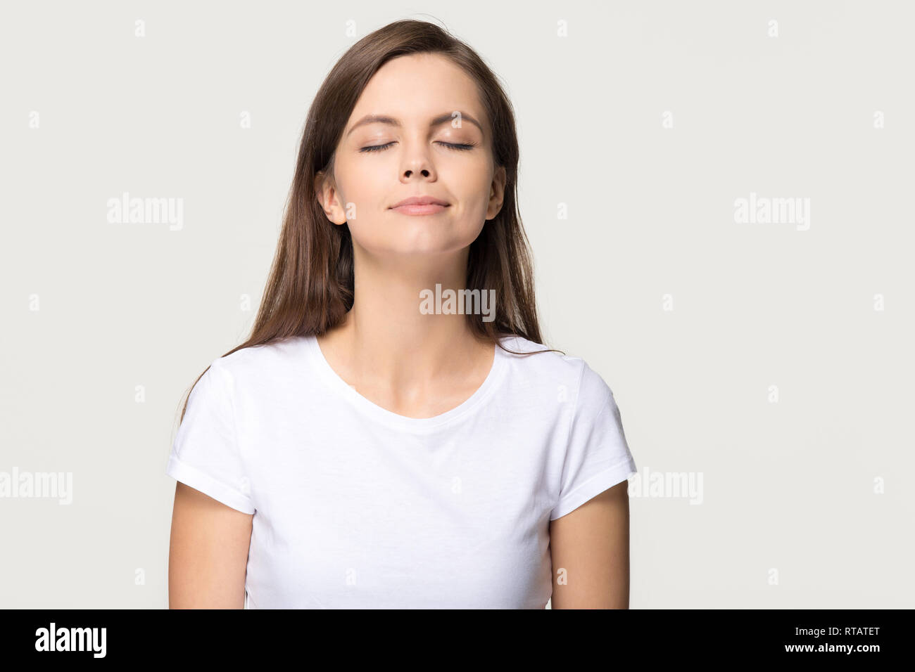 Happy calm girl enjoying good smell breathing fresh air isolated Stock