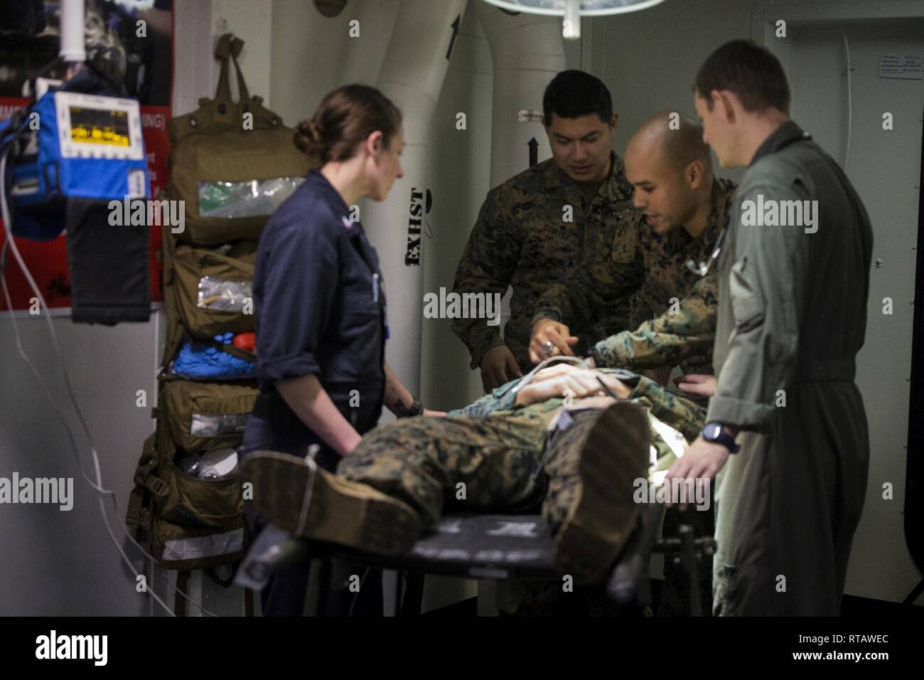 U.S. Navy medical providers with Combat Logistics Battalion 31, the 31st Marine Expeditionary Unit and the amphibious assault ship USS Wasp (LHD 1) treat a simulated casualty inside medical bay during a mass-casualty exercise while underway in the East China Sea, Feb. 4, 2019. During the exercise, dubbed “Nightingale,” Navy doctors and hospital corpsmen triaged simulated casualties to refine their ability to respond in the event of a mass-casualty scenario. The 31st MEU, the Marine Corps’ only continuously forward-deployed MEU partnering with the Wasp Amphibious Ready Group, provides a flexibl Stock Photo