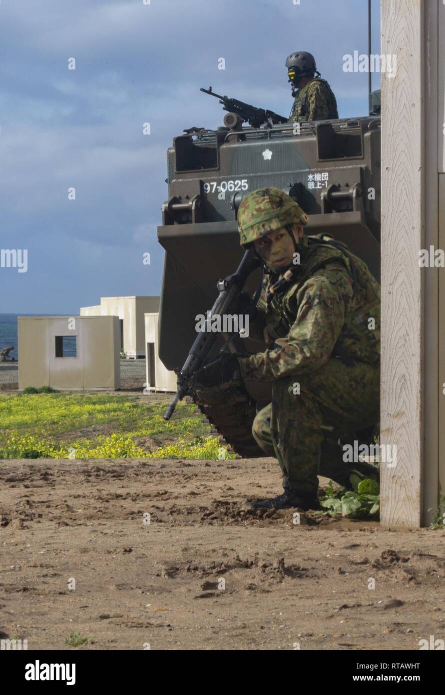 Japan Ground Self-Defense Force (JGSDF) Soldier with 1st Amphibious Rapid Deployment Regiment, patrols alongside a assault amphibious vehicles through urban operations during an amphibious landing exercise for Iron Fist 2019, Feb. 4, on U.S. Marine Corps Base Camp Pendleton, CA. Exercise Iron Fist is an annual, multilateral training exercise where U.S. and Japanese service members train together and share techniques, tactics and procedures to improve their combined operational capabilities. Stock Photo