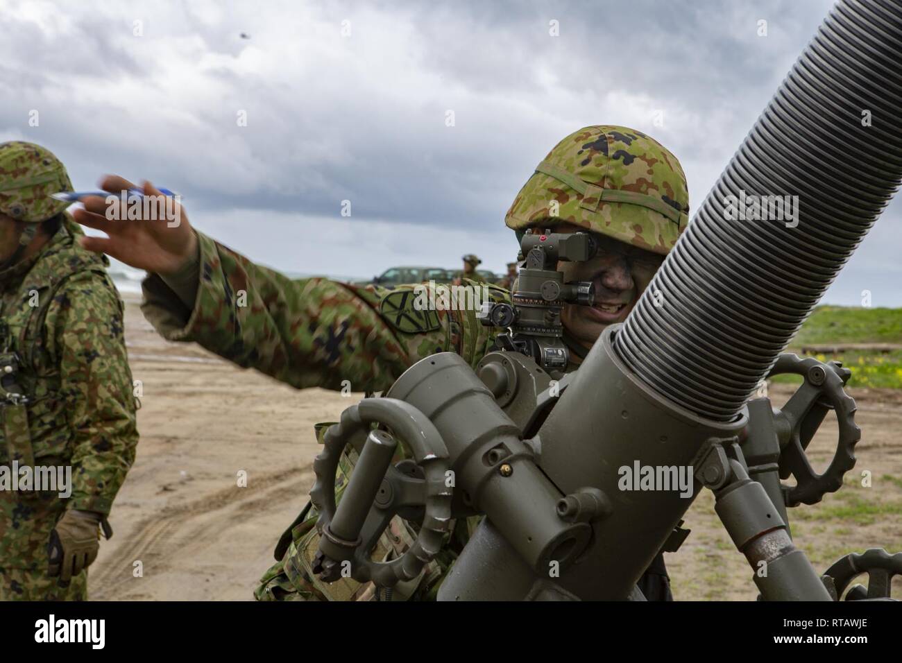 Japan Ground Self-Defense Force (JGSDF) Soldier checks the sights of a 120mm mortar during an amphibious landing exercise for Iron Fist 2019, Feb. 4, on U.S. Marine Corps Base Camp Pendleton, CA. Exercise Iron Fist is an annual, multilateral training exercise where U.S. and Japanese service members train together and share techniques, tactics and procedures to improve their combined operational capabilities. Stock Photo
