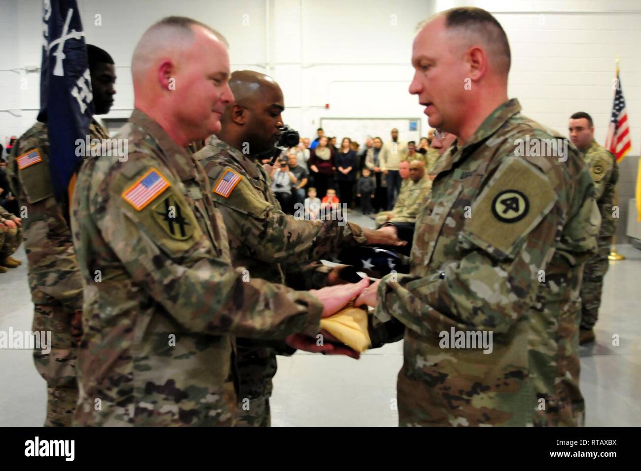 Col. Robert Hughes, commander, 44th Infantry Brigade Combat Team, presents the New Jersey state