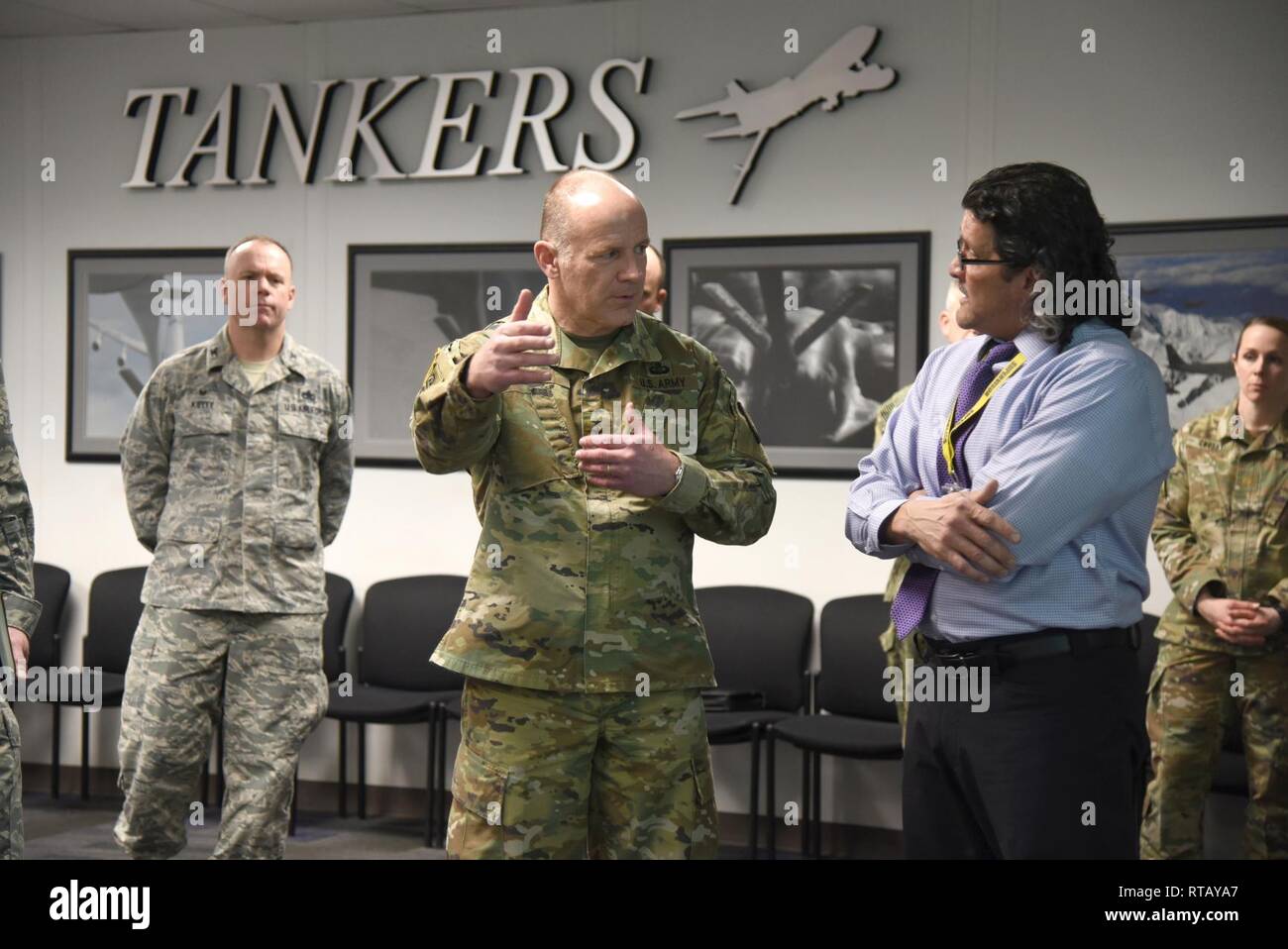 Gen. Stephen Lyons, left, United States Transportation Command commander  speaks with Mark Estorga, 564th Aircraft Maintenance Squadron director,  about the KC-135's Programmed Depot Maintenance process, major structural  repairs and the sustainability of