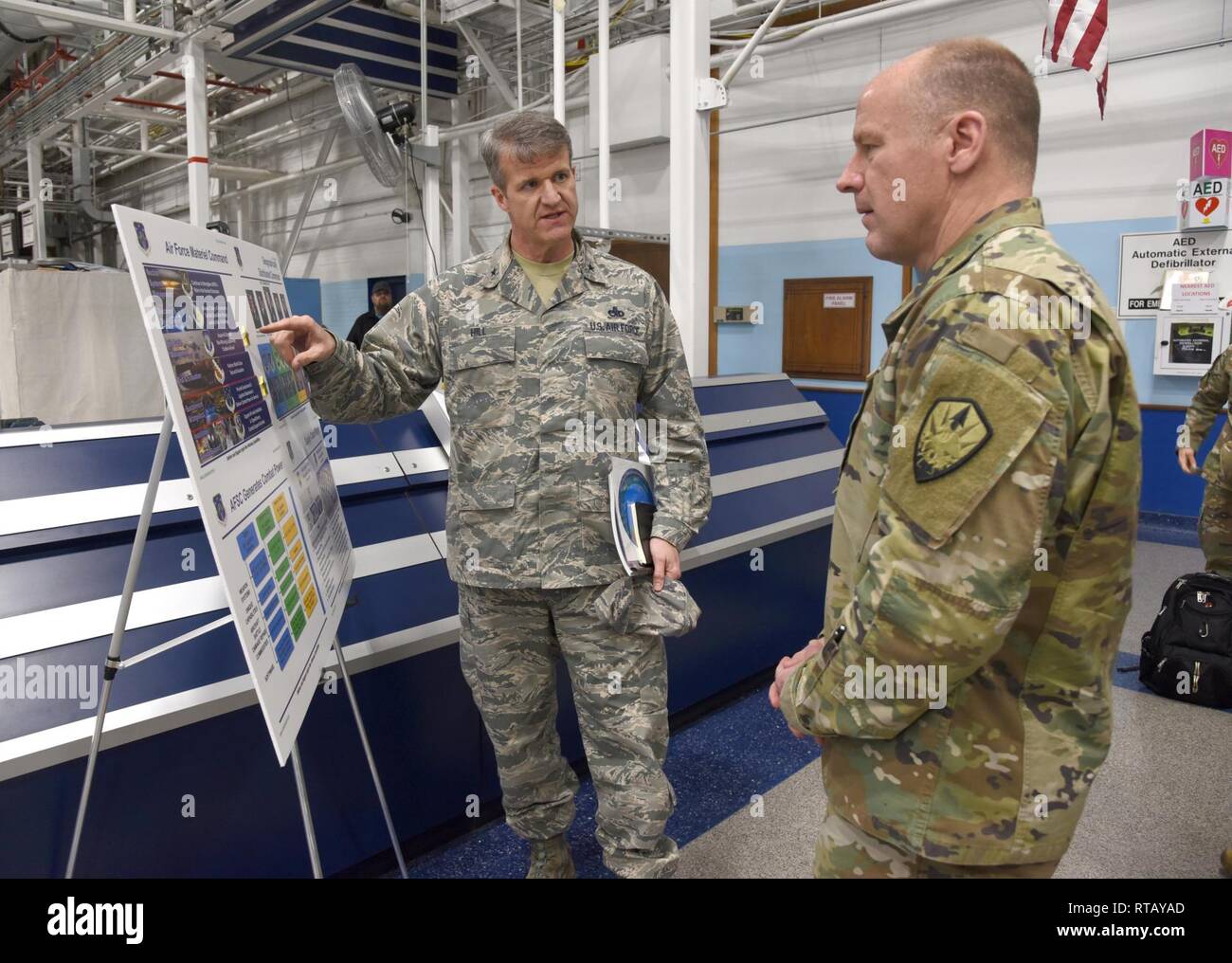 Brig. Gen. Chris Hill, Oklahoma City Air Logistics Complex commander briefs Gen. Stephen Lyons, United States Transportation Command commander, on the internal structure of the Air Force Sustainment Center and the OC-ALC mission. Gen. Lyons toured several locations around Tinker Air Force Base Feb. 4. Lyons was briefed on the programmed depot maintenance of the KC-135 and modifications in progress, the REACT lab and the KC-46A depot activation timeline and critical path, including partnering initiatives, Milcon and the KC-46 Sustainment Campus. Stock Photo