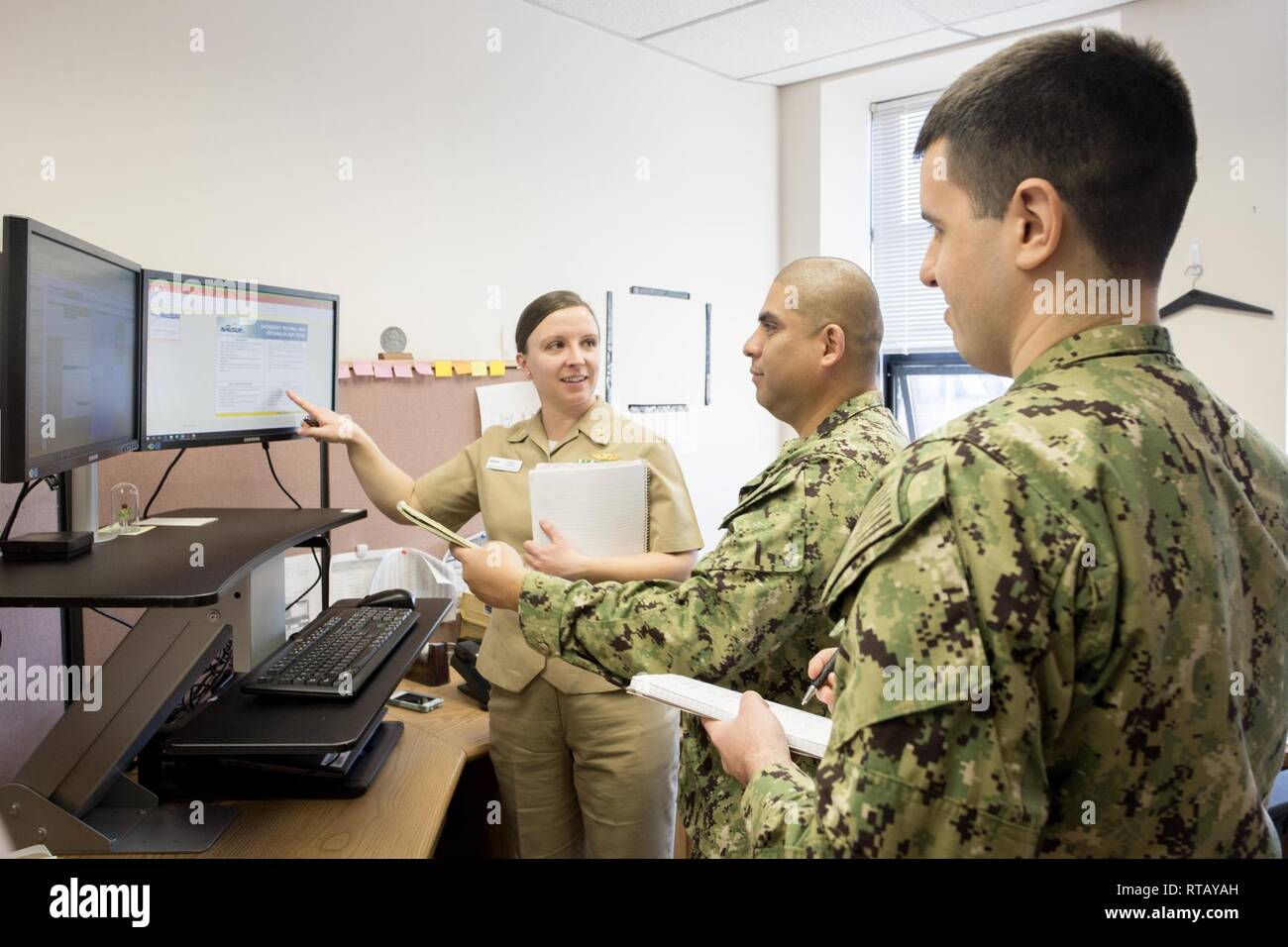 NSA PHILADELPHIA (Feb. 4, 2019) -- U.S. Navy Reserve logistics officers Lt. Cmdr. Anna Harris, Lt. Robert Romero and Lt. Douglas Macintosh discuss oversight testing for Naval Air Station Oceana on Feb. 4, 2019. The officers are part of NAVSUP WSS's Inventory Operations Center. Stock Photo