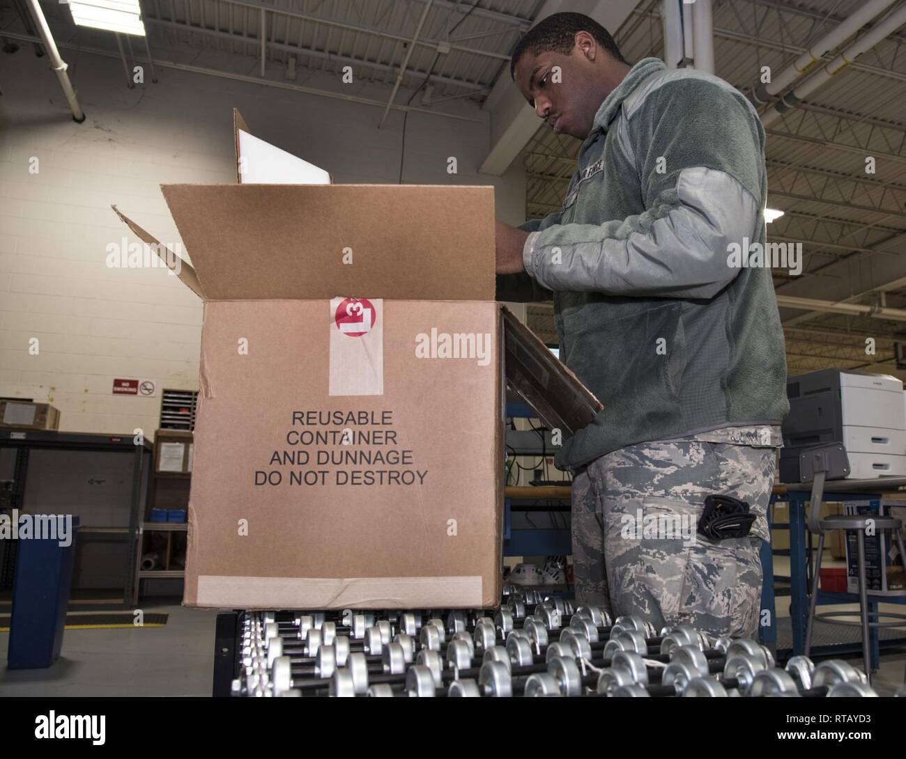 Airman Anthony Lemarc Cole Jr., a traffic management specialist, 108th Logistics Readiness Squadron, processes an in-coming package in the LRS supply warehouse at Joint Base McGuire-Dix-Lakehurst, N.J., Feb. 4, 2019. Cole's long-term goal is to become proficient in his Air Force Specilty Code and to one day become a chief master sergeant. Stock Photo