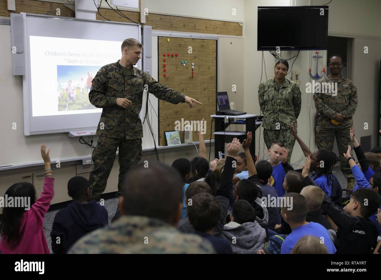 Navy Lt. Michael J. Lawrence, left, gives instructions to students from