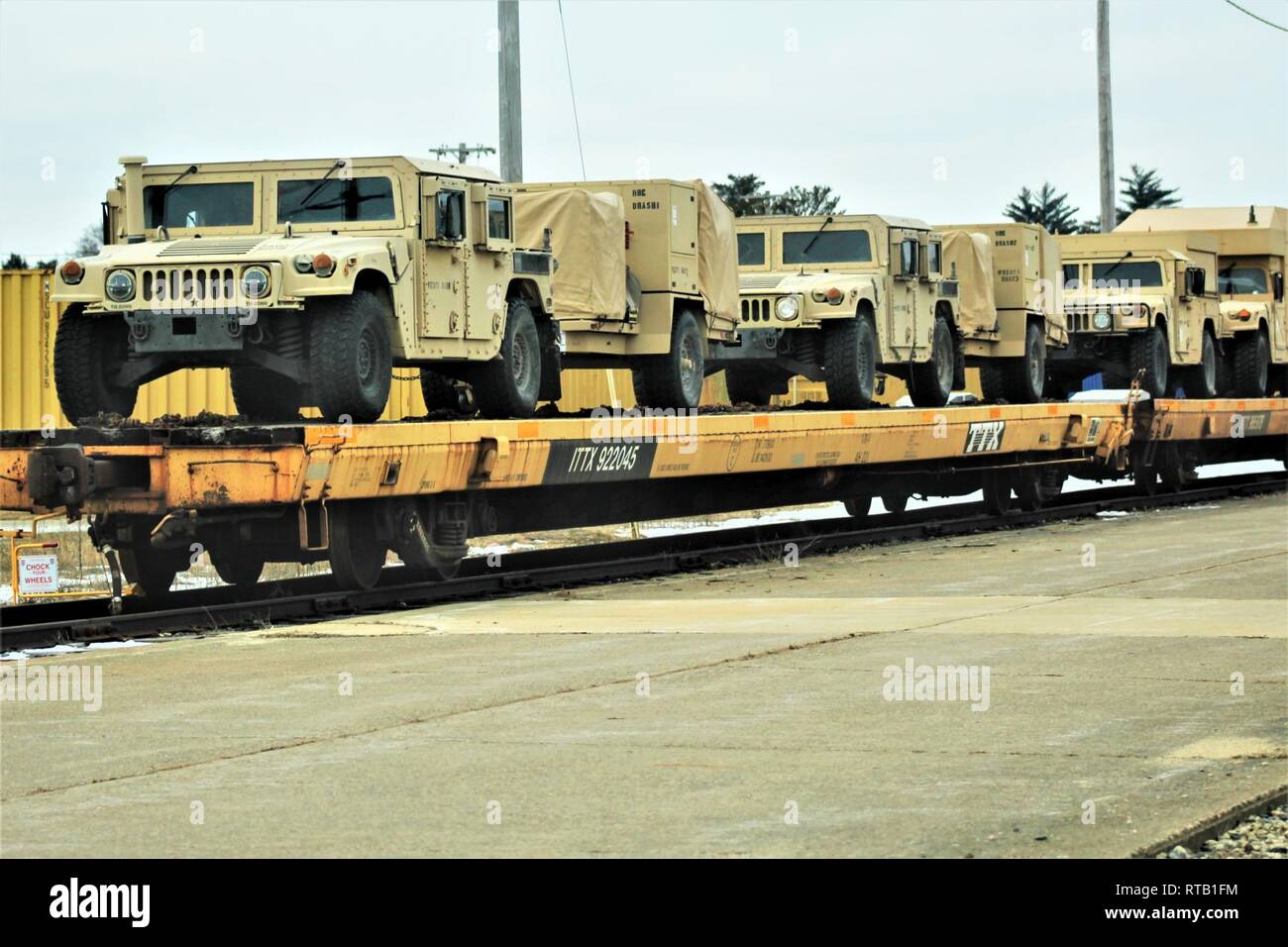 Military vehicles and equipment with the 389th Engineer Battalion is loaded on railcars Feb. 5, 2019, at the rail yard at Fort McCoy, Wis. The movement is for the 389th’s future involvement in Operation Resolute Castle 2019 in Poland. Unit Soldiers loaded 38 cars with vehicles and equipment after receiving training in a rail head operations class by representatives of Marine Corps Logistics Base-Barstow, Calif. Fort McCoy’s Logistics Readiness Center personnel assisted with the loading operations. Stock Photo