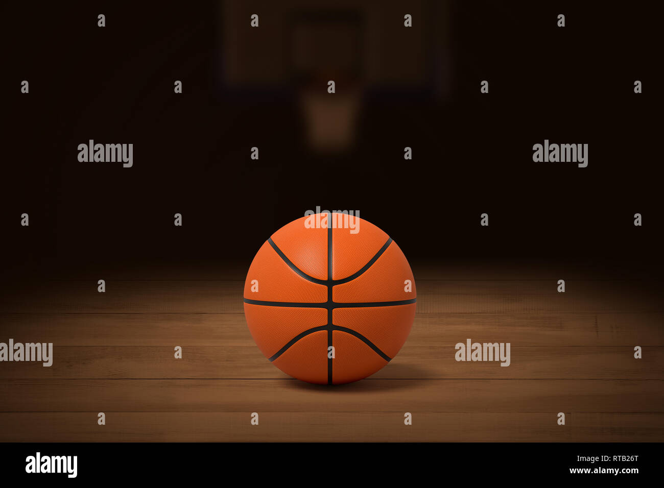 3d rendering of a basketball on the wooden floor in a dimly lit gym with a blurred image of the basket in the background. Stock Photo