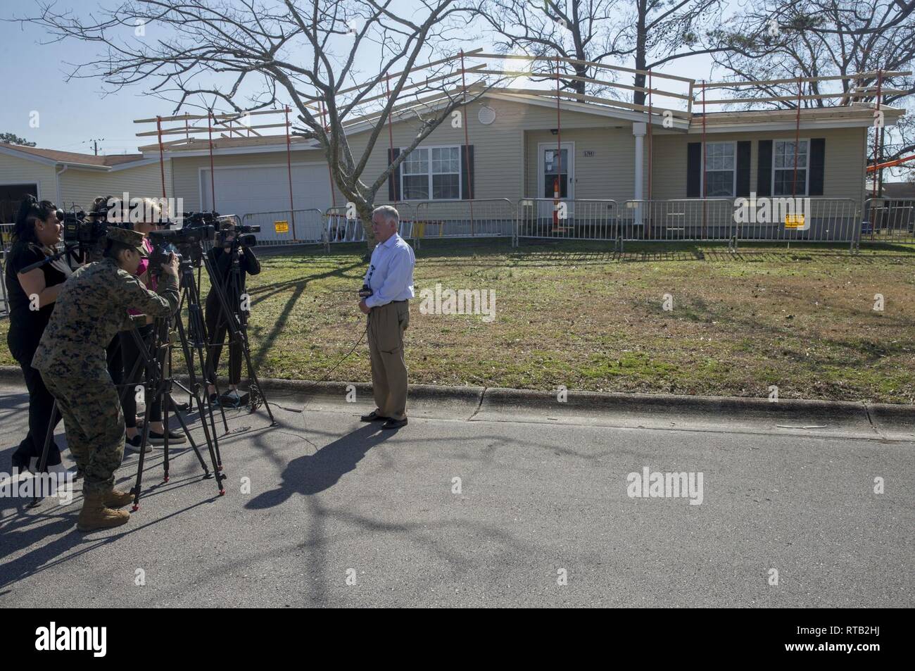 Mr. Phillip Carpenter, chief operating officer, LendLease Communities, gives his remarks to local media during a tour of the base housing communities on Marine Corps Base Camp Lejeune, North Carolina, Feb. 6, 2019. Base leadership extended an invitation for local media outlets to tour the installation, including housing areas and Onslow Beach, to see first-hand how the base is conducting daily operations in a degraded environment and how repairs are progressing nearly 5 months after the storm damaged over 800 buildings on Marine Corps installations in North Carolina. Stock Photo