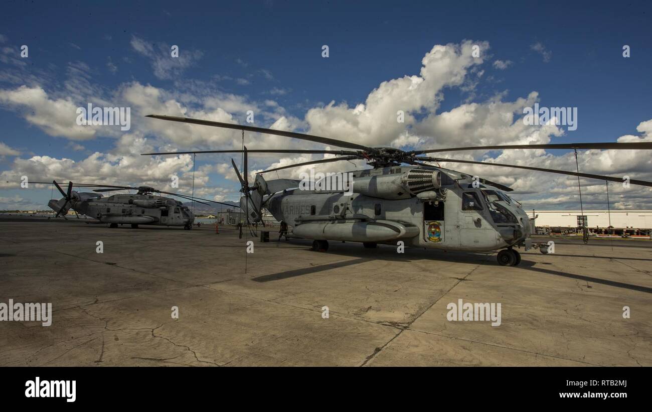 U.S. Marines with Marine Heavy Helicopter Squadron 363 (HMH-363) stage CH-53E Super Stallions on Pearl Harbor, Hawaii, Feb. 6, 2019. HMH-363 staged their aircraft prior to loading aircraft onto a ship for their upcoming deployment. Stock Photo