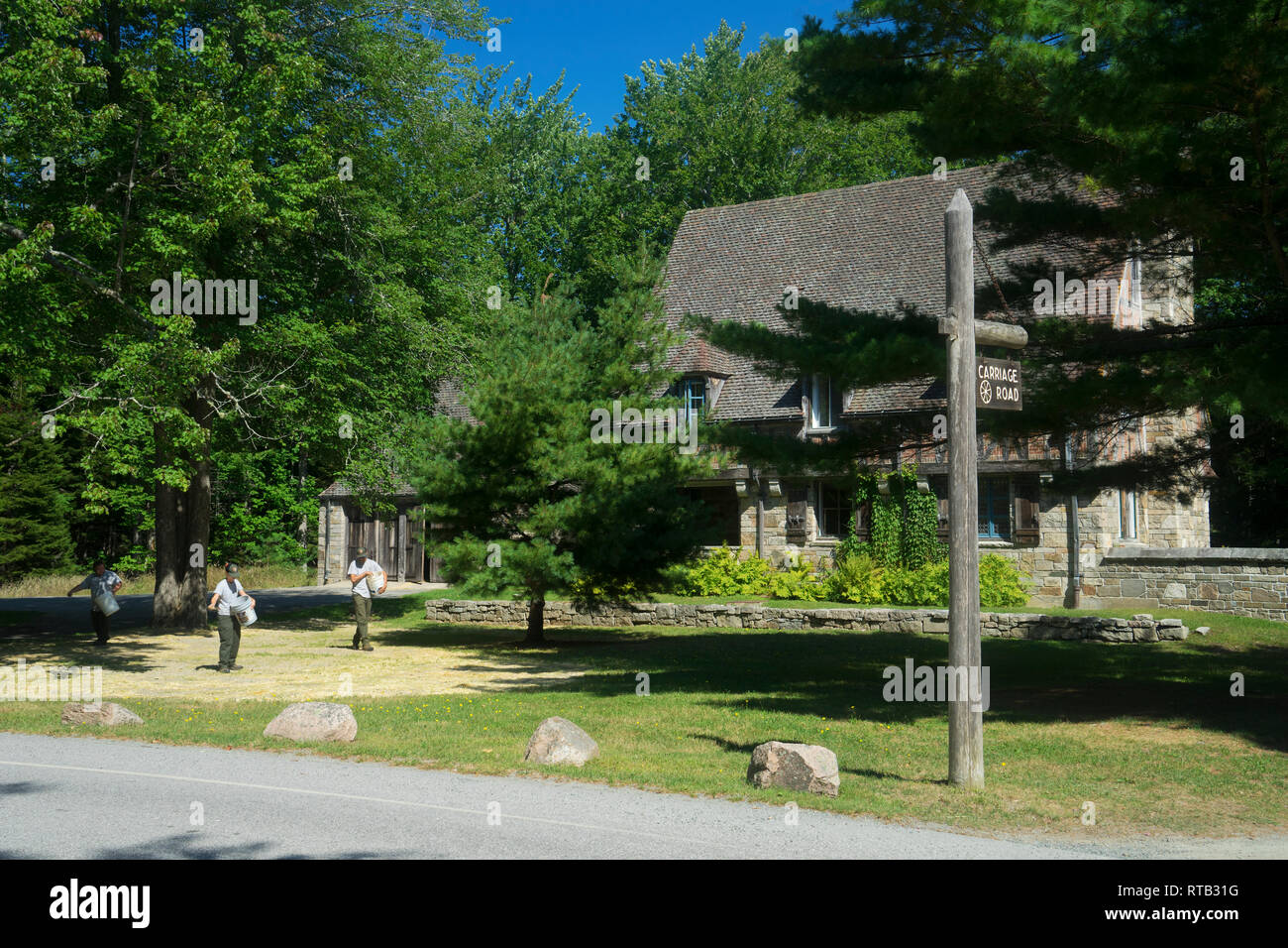 Park employees applying fertilizer to the lawn at Jordan Pond Gate House, Acadia National Park, Maine, USA. Stock Photo