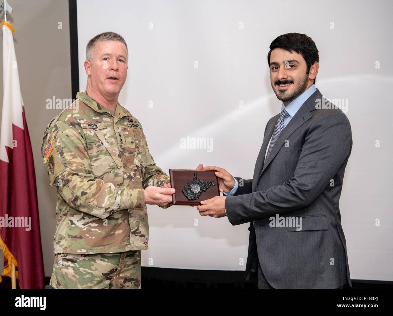 Maj. Gen. James Hoyer, Adjutant General of the West Virginia National Guard, presents Qatar Ministry of Interior representative Mohammed Al-Sowaidi with a gift during the Leader Development & Education for Sustained Peace (LDESP) Seminar on Qatar Feb. 6, 2019, in Charleston, W.Va. LDESP is a Department of Defense ) organization at the Naval Postgraduate School (NPS) in Monterey, California, that prepares senior military and civilian U.S. leaders for short and long-term engagement in Africa, the Pacific, the Middle East, Europe and other regions around the world. Stock Photo