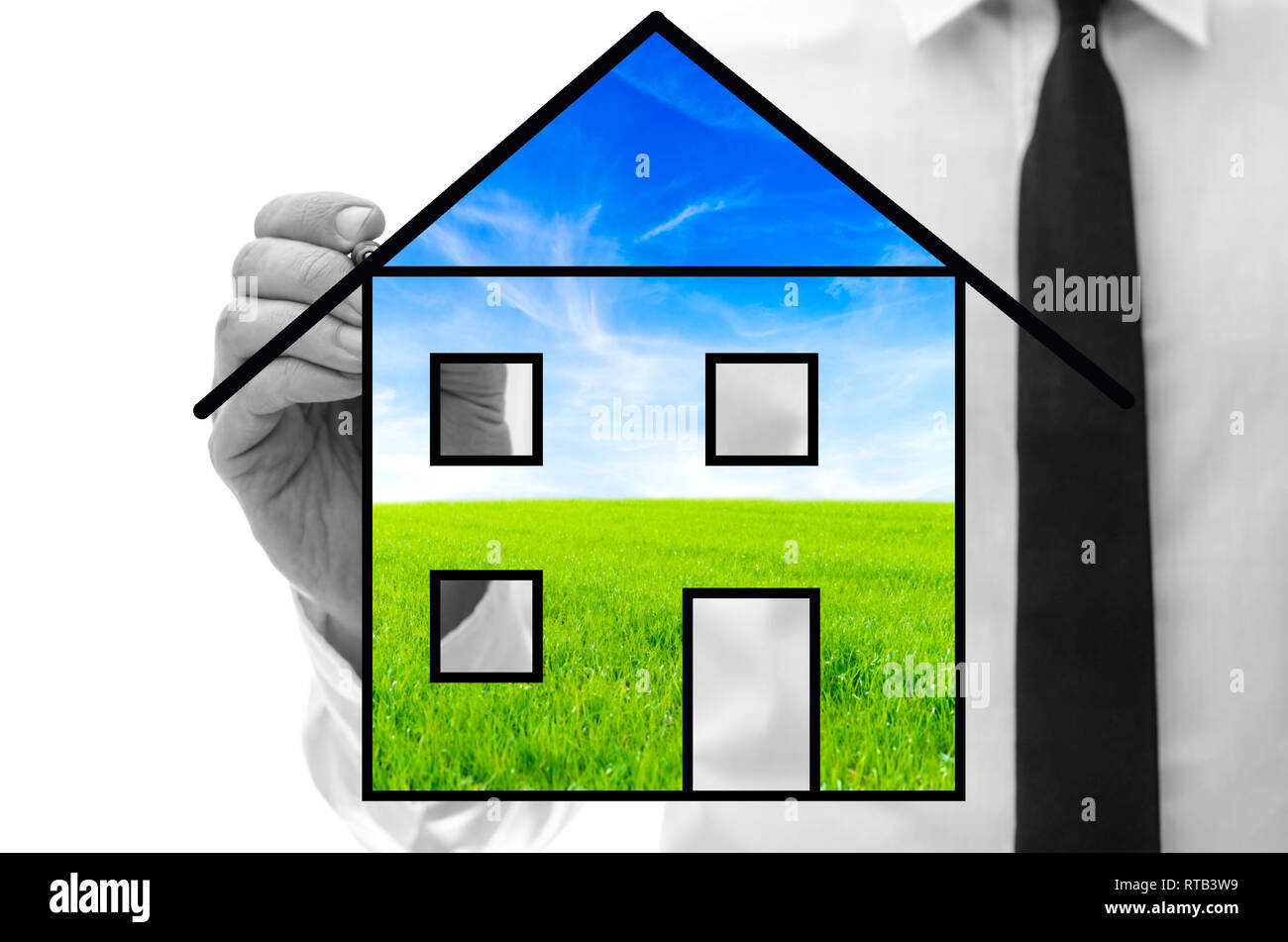 Man drawing eco house on virtual screen. Stock Photo