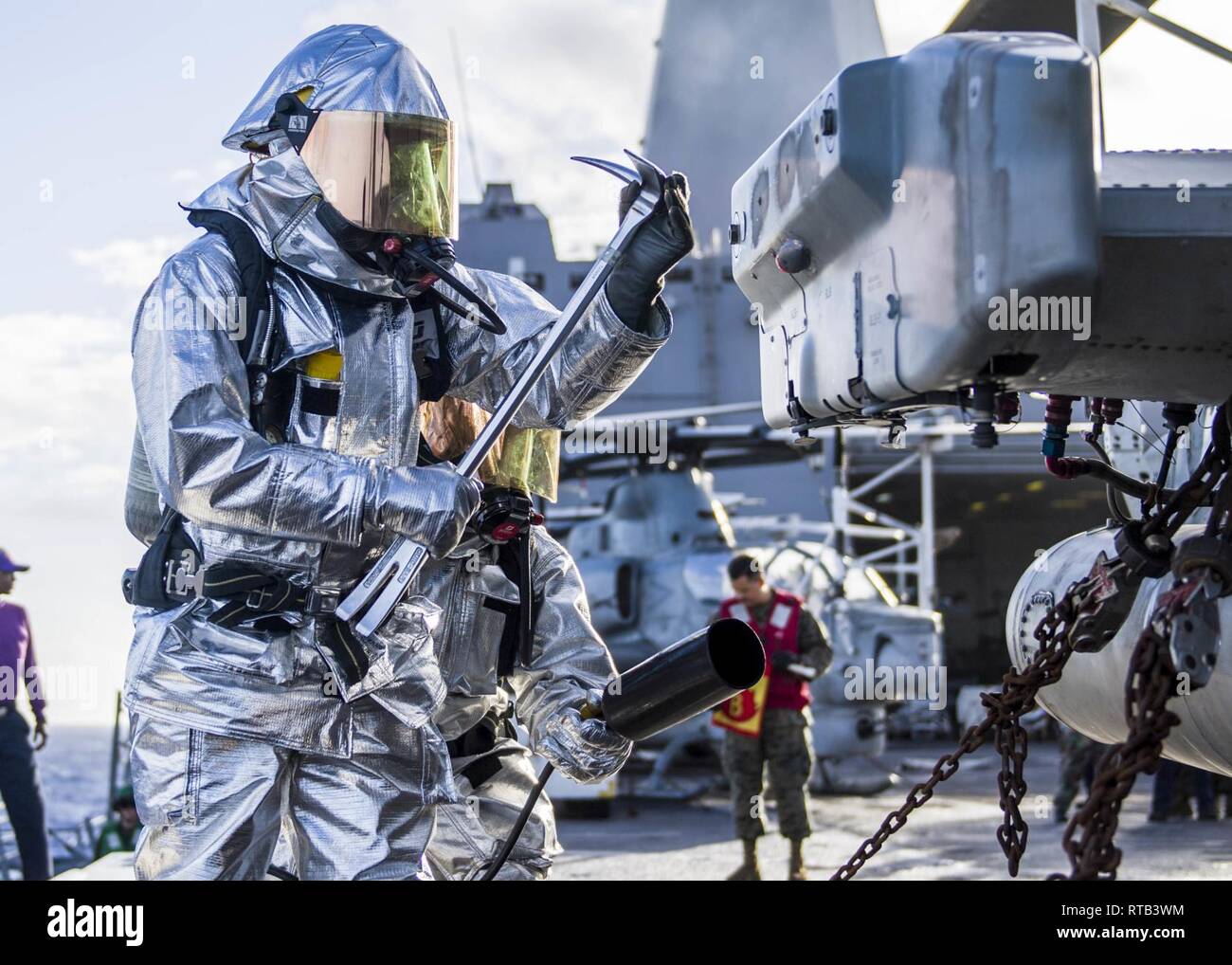PACIFIC OCEAN (Feb. 6, 2019) Aviation Boatswain’s Mate (Handling) 3rd Class Frederick Medina, from Delano, California, searches for simulated hot spots during a flight deck fire drill aboard the San Antonio-class amphibious transport dock ship USS Anchorage (LPD 23) while on a deployment of the Essex Amphibious Ready Group (ARG) and 13th Marine Expeditionary Unit (MEU). The Essex ARG/13th MEU is a capable and lethal Navy-Marine Corps team deployed to the 7th fleet area of operations to support regional stability, reassure partners and allies and maintain a presence postured to respond to any c Stock Photo