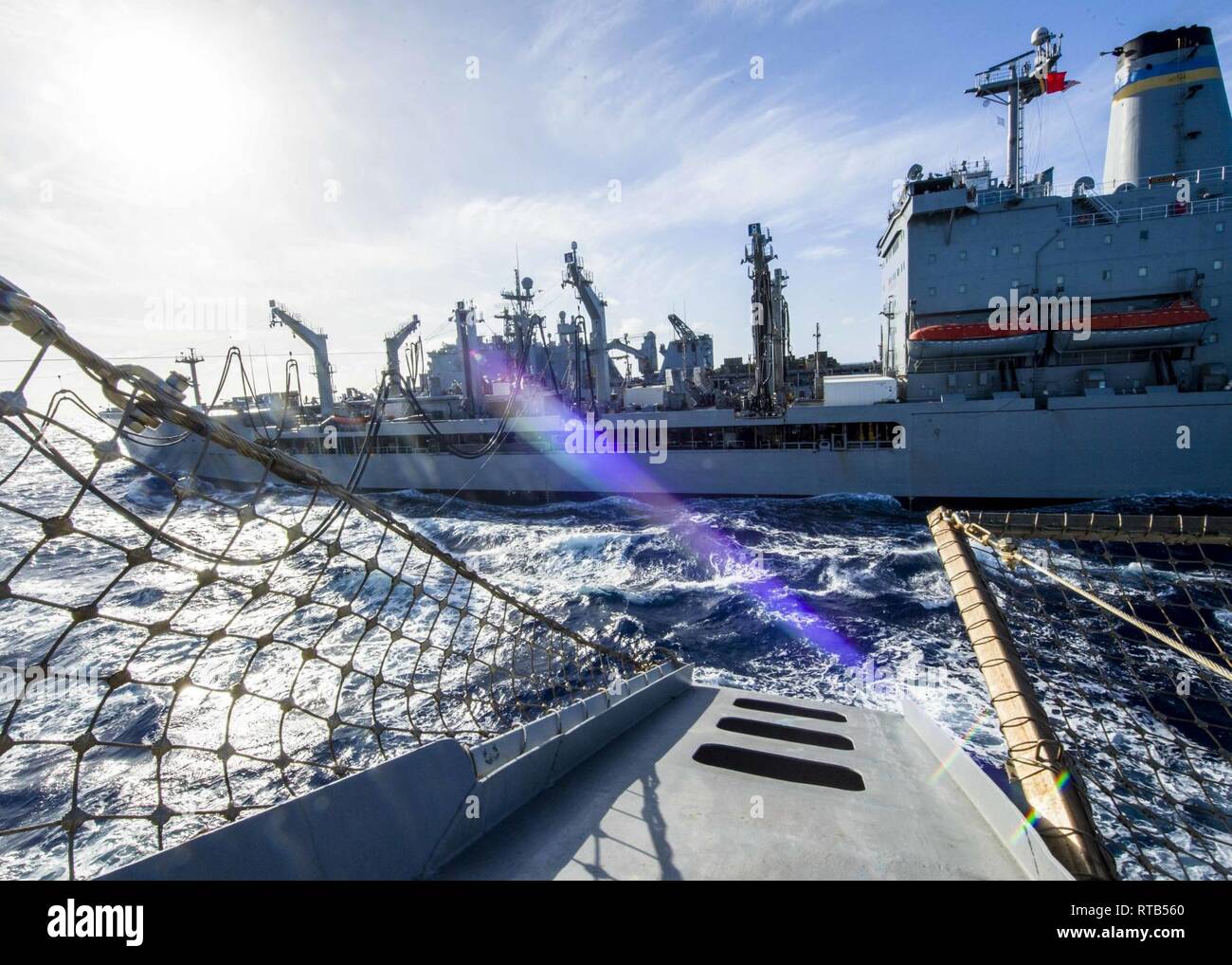 PACIFIC OCEAN (Feb. 7, 2019) The San Antonio-class amphibious transport dock ship USS Anchorage (LPD 23) participates in an underway replenishment with fleet replenishment oiler USNS Pecos (T-AO 197) while on a deployment of the Essex Amphibious Ready Group (ARG) and 13th Marine Expeditionary Unit (MEU). The Essex ARG/13th MEU is a capable and lethal Navy-Marine Corps team deployed to the 7th fleet area of operations to support regional stability, reassure partners and allies and maintain a presence postured to respond to any crisis ranging from humanitarian assistance to contingency operation Stock Photo