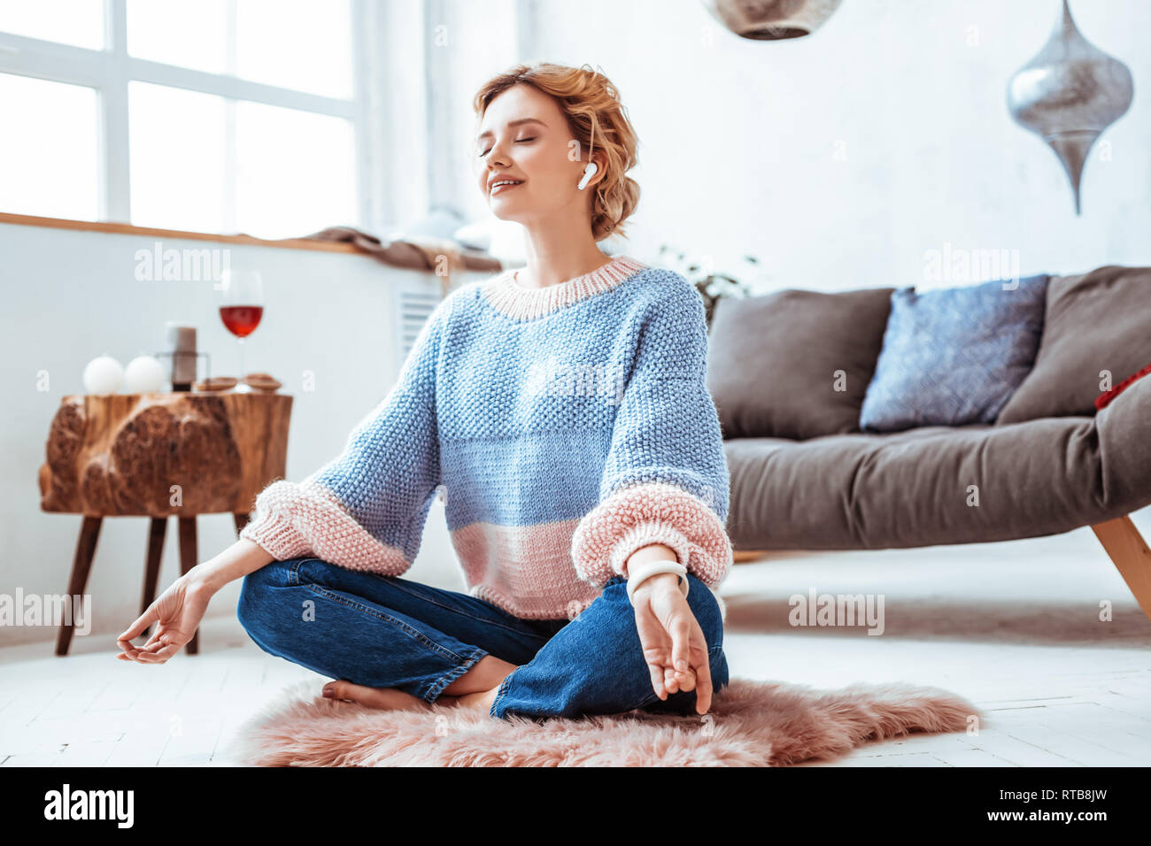 Beautiful nice woman practicing yoga at home Stock Photo