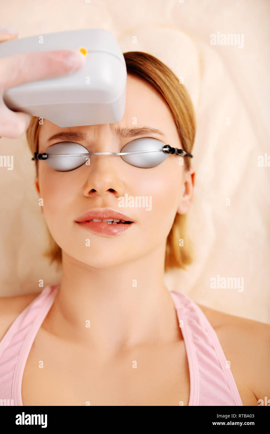 Woman feeling some pain making photo depilation of face Stock Photo Alamy
