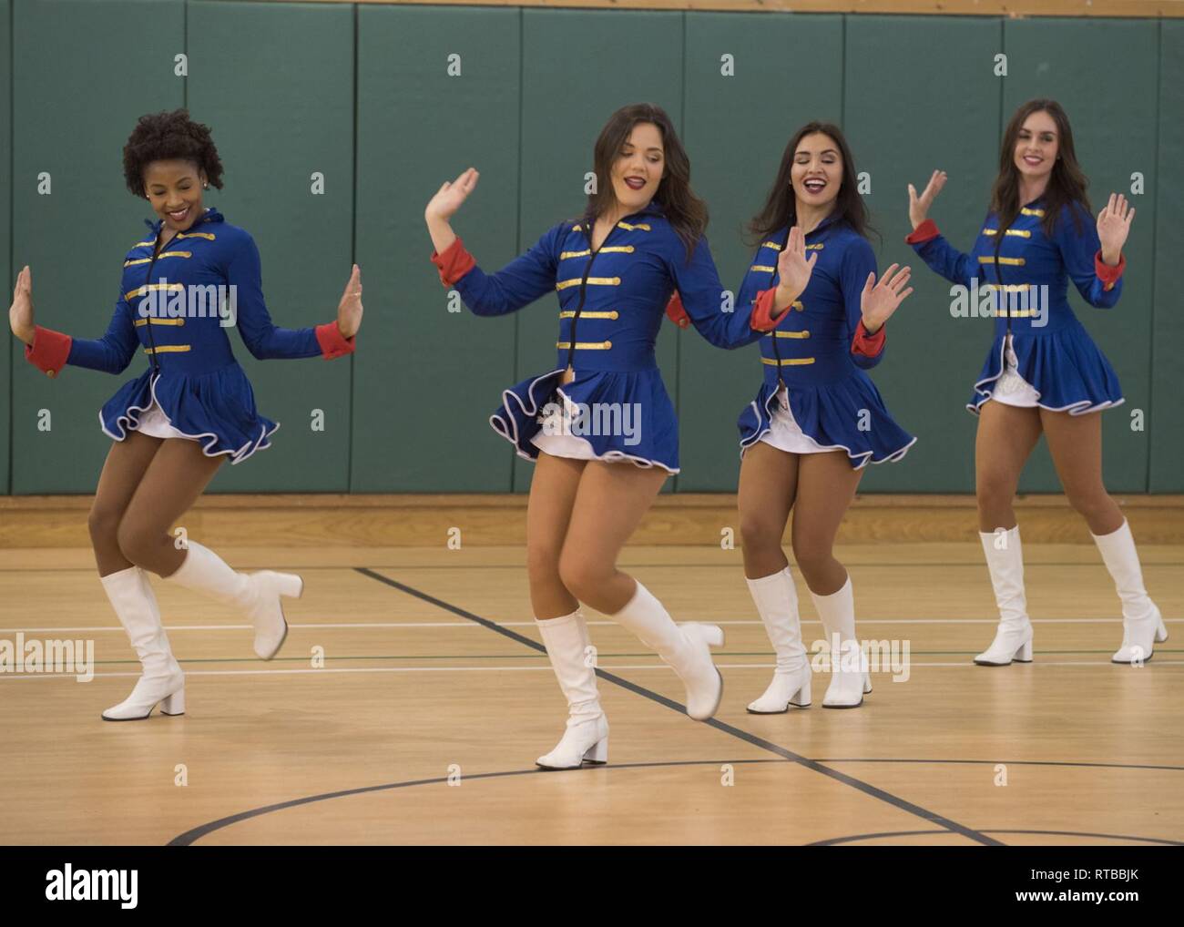 423rd Force Support Squadron hosts the Miami Dolphin Cheerleaders Feb. 2, 2019, at RAF Alconbury, United Kingdom during the 2019 Superbowl weekend. The cheerleaders conducted a cheer camp for base personnel. Stock Photo