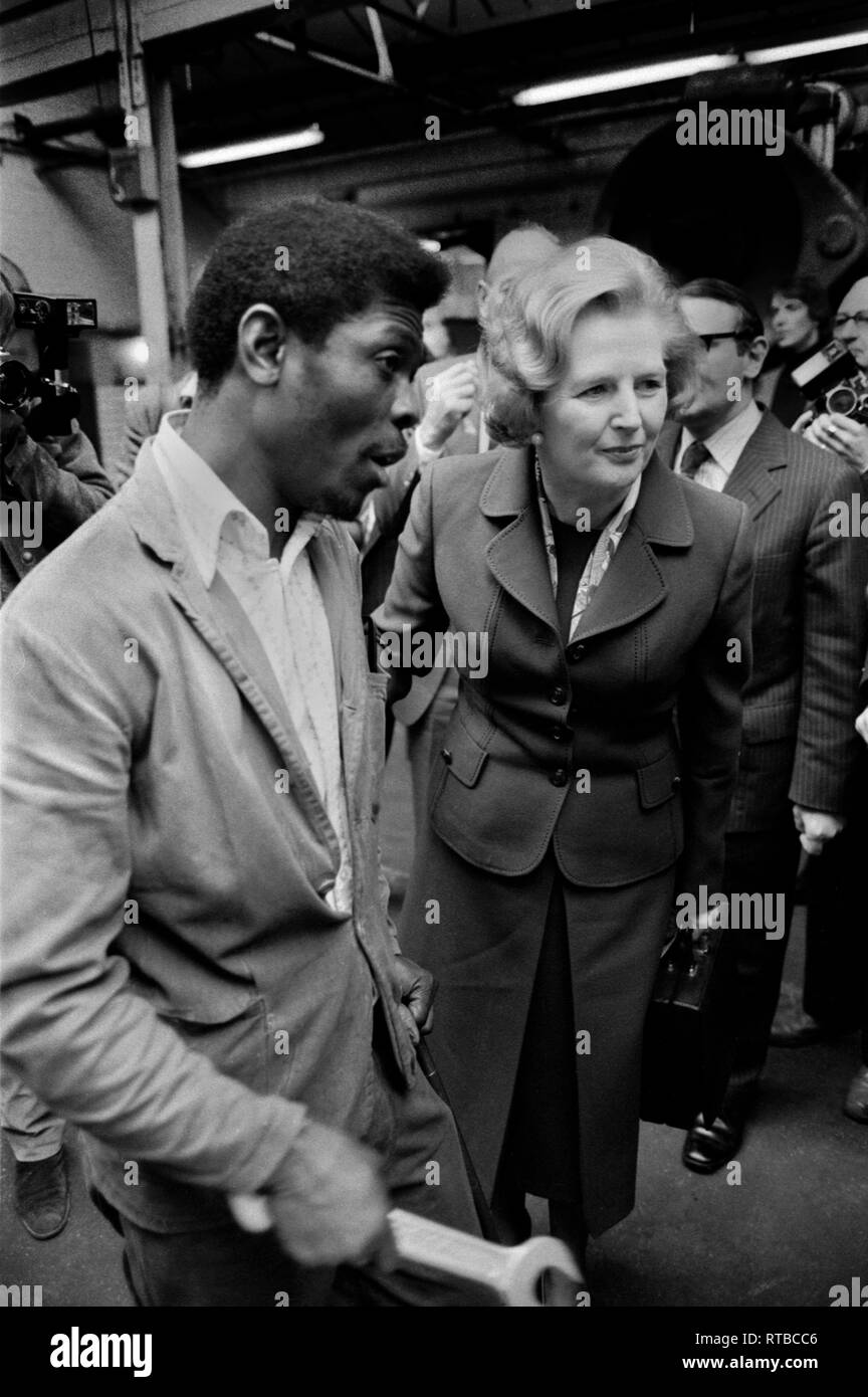 Mrs Margaret Thatcher 1979 General Election on the campaign trail. Factory visit in the West Midlands. Talking to black male factory worker. 1970s UK HOMER SYKES Stock Photo