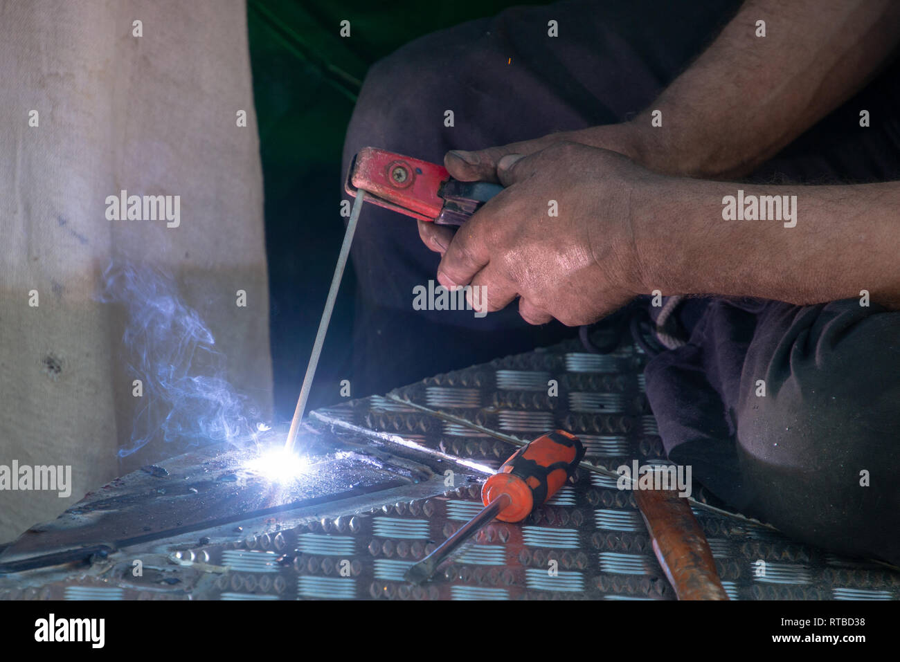 man using electric arc welder Stock Photo