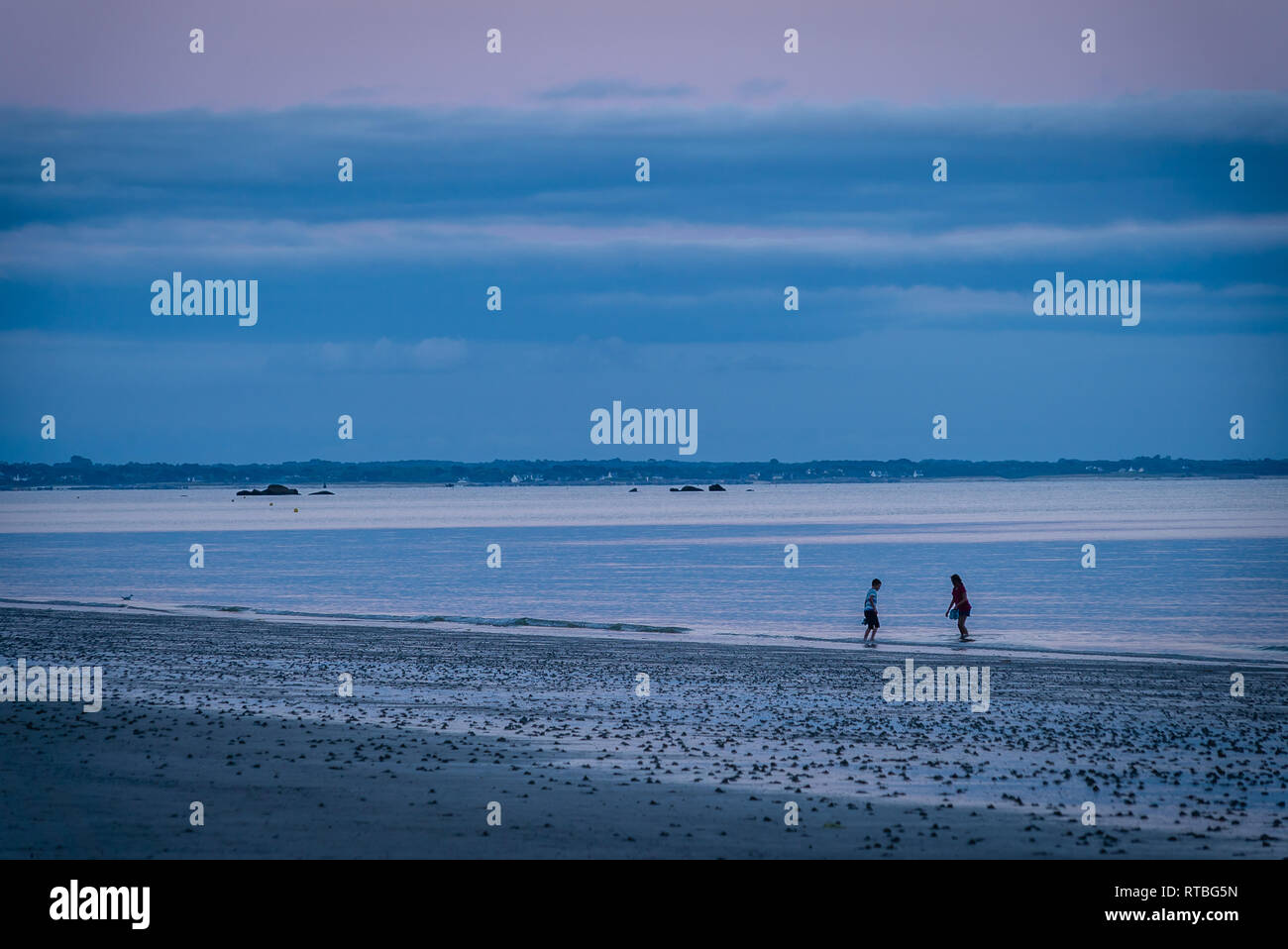 Children on holidays in France playing in the ocean in Mousterlin Stock Photo