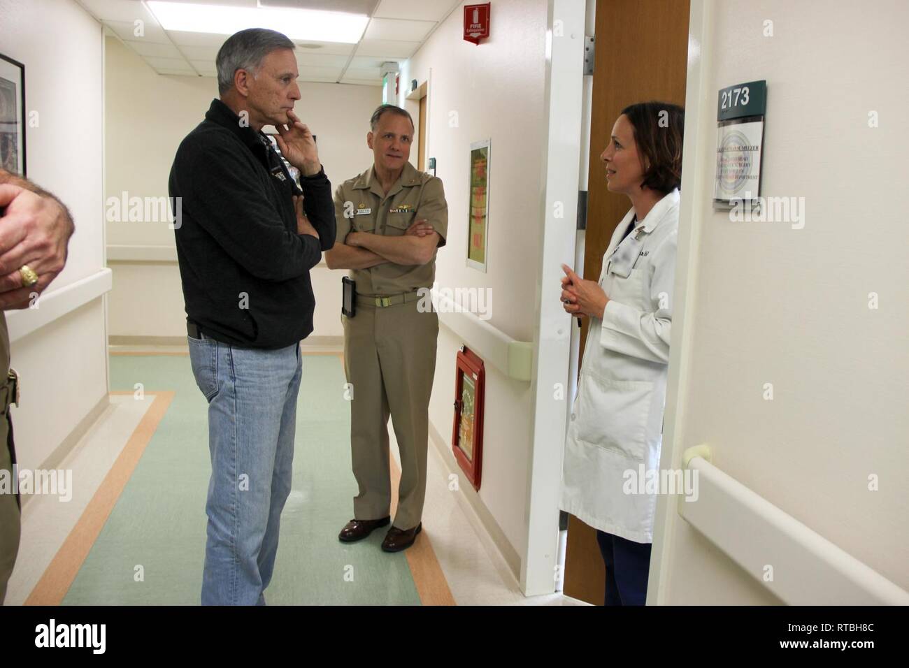 Assistant Secretary of the Navy (Manpower and Reserve Affairs) Gregory J. Slavonic (left) talks with Cmdr. Suzanne Gudeman about her role as a 'circuit rider' within the European area.  Cmdr. Gudeman, a urologist, is based out of U.S. Naval Hospital Rota and performs regular rotations through U.S. Naval Hospital Naples, Italy. Stock Photo