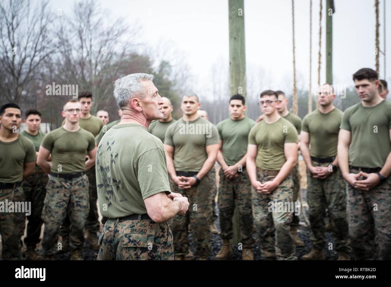 Director of the Martial Arts Center of Excellence and the Force Fitness Readiness Center, Lt. Col. (ret) Joseph Shusko delivers a tie-in following a physical training exercise during the Force Fitness Instructor (FFI) Course, Quantico, Va., Feb 8, 2019. Shusko provided a reminder that as FFIs, they will need to act as constant mentors to junior Marines in order to create and inspire the next generation of effective leaders. Stock Photo