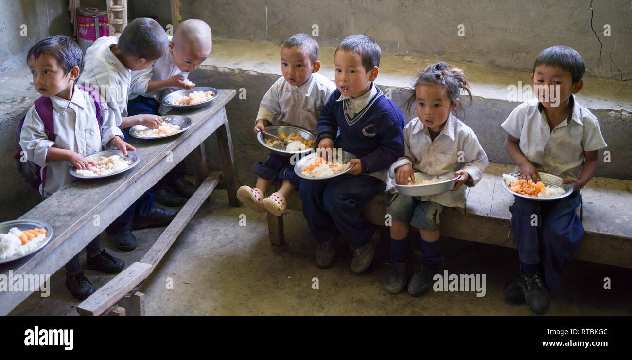 School children having midday meal in school, Radhu Khandu Village
