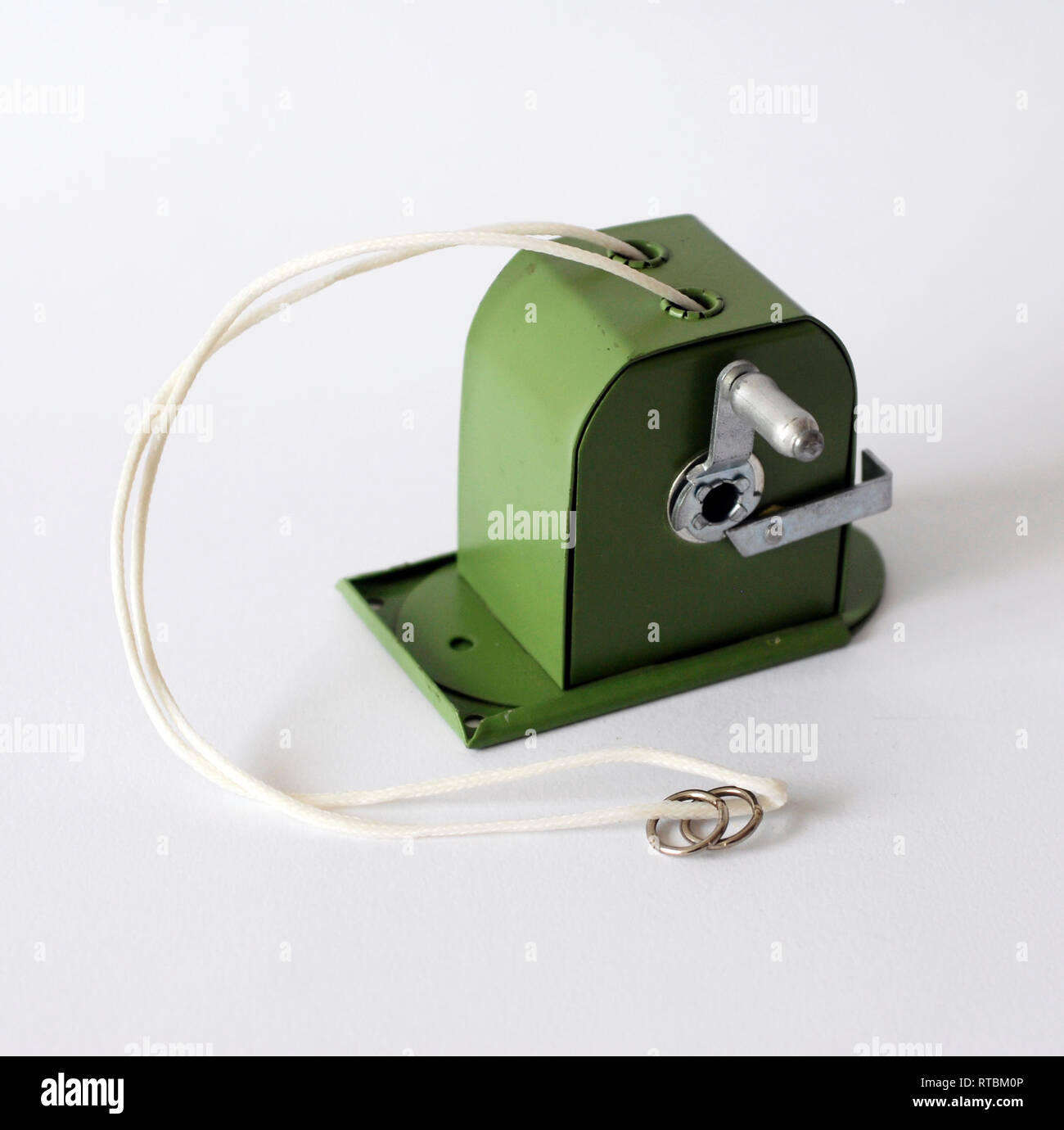 Photograph of a vintage green metal clothesline isolated on white