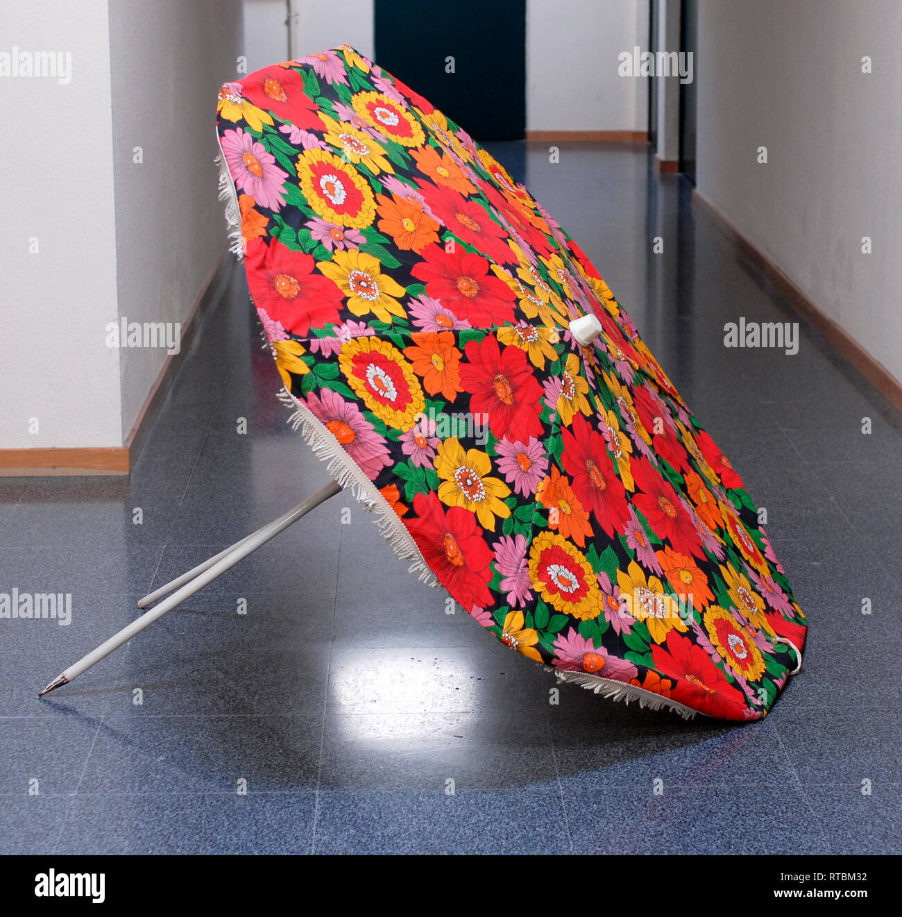 Vintage beach umbrella in fabric with flowers, photographed indoors Stock  Photo - Alamy
