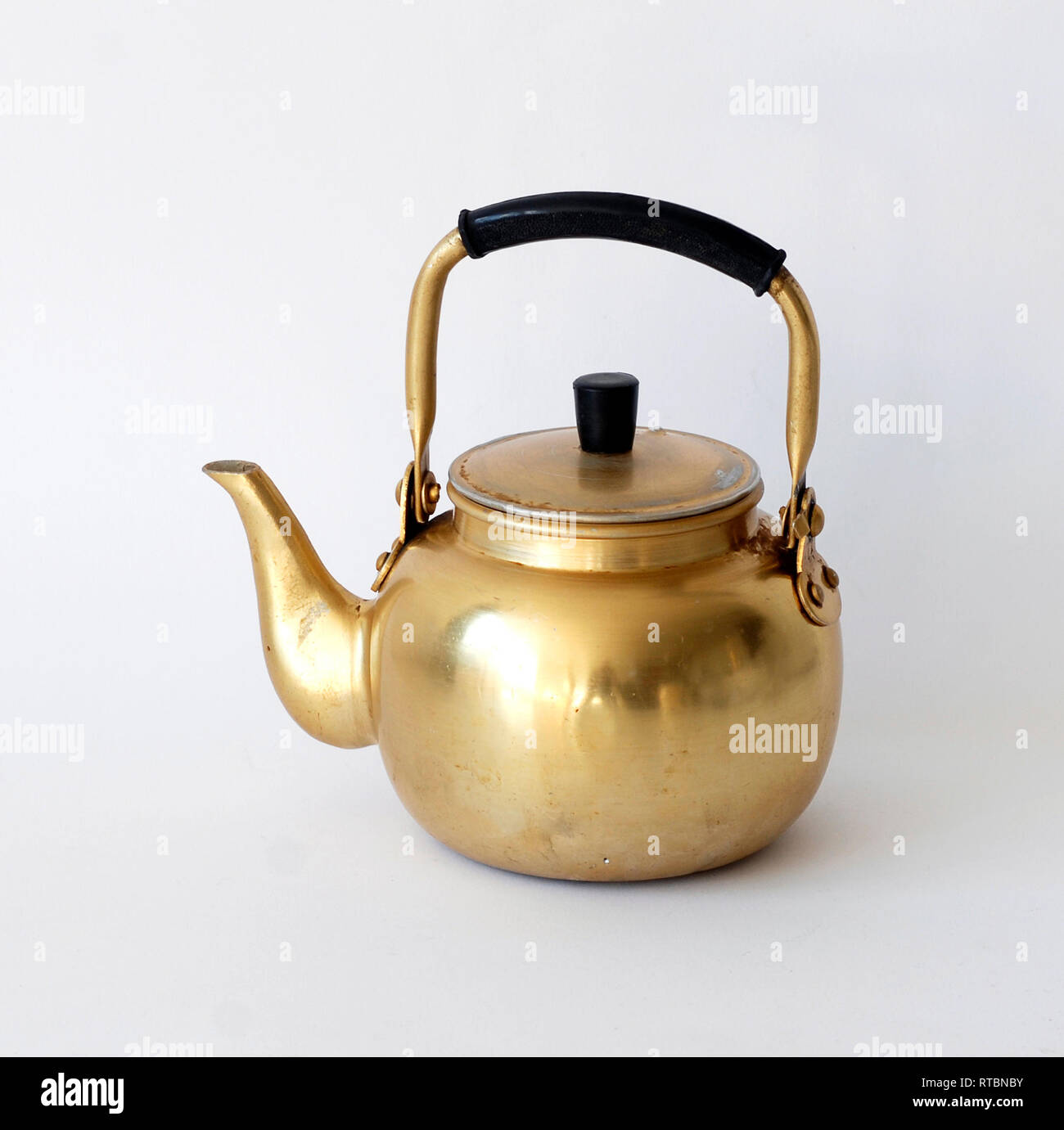 Beautiful golden vintage kettle isolated on white background Stock Photo -  Alamy