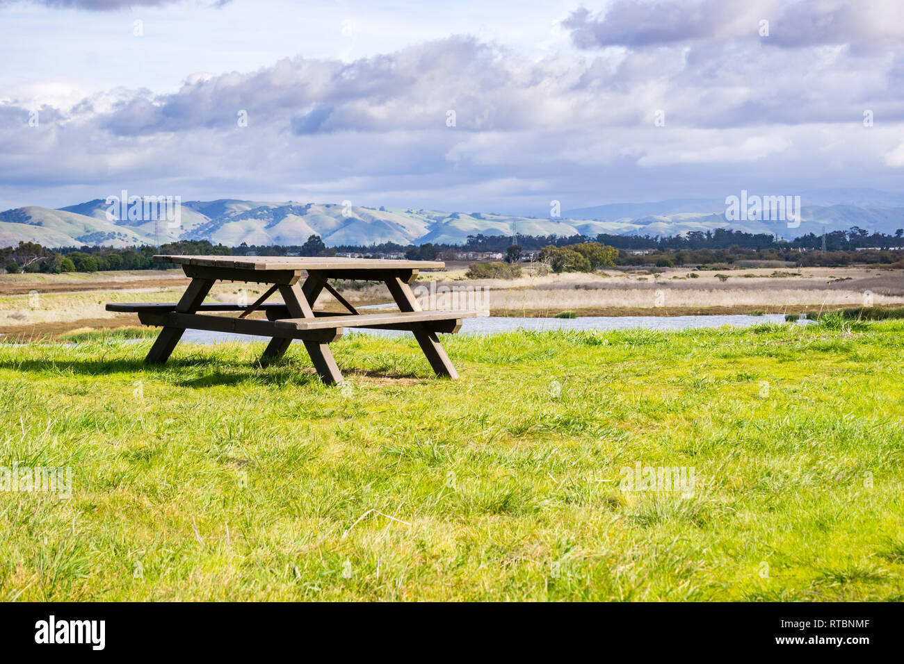 Bench Region Picnic bench near a pond, mountain background, Coyote Hills Regional ...