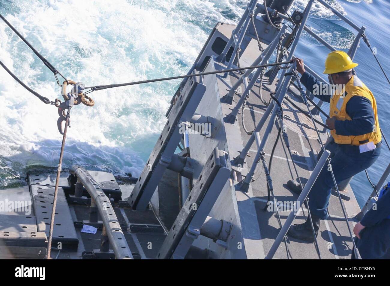 ARABIAN GULF (Feb. 9, 2019) Information Systems Technician 1st Class Clarance Duncan secures a line aboard the Cyclone-class coastal patrol ship USS Thunderbolt (PC 12). Thunderbolt is forward deployed to the U.S. 5th Fleet area of operations in support of naval operations to ensure maritime stability and security in the Central region, connecting the Mediterranean and the Pacific through the western Indian Ocean and three strategic choke points. Stock Photo