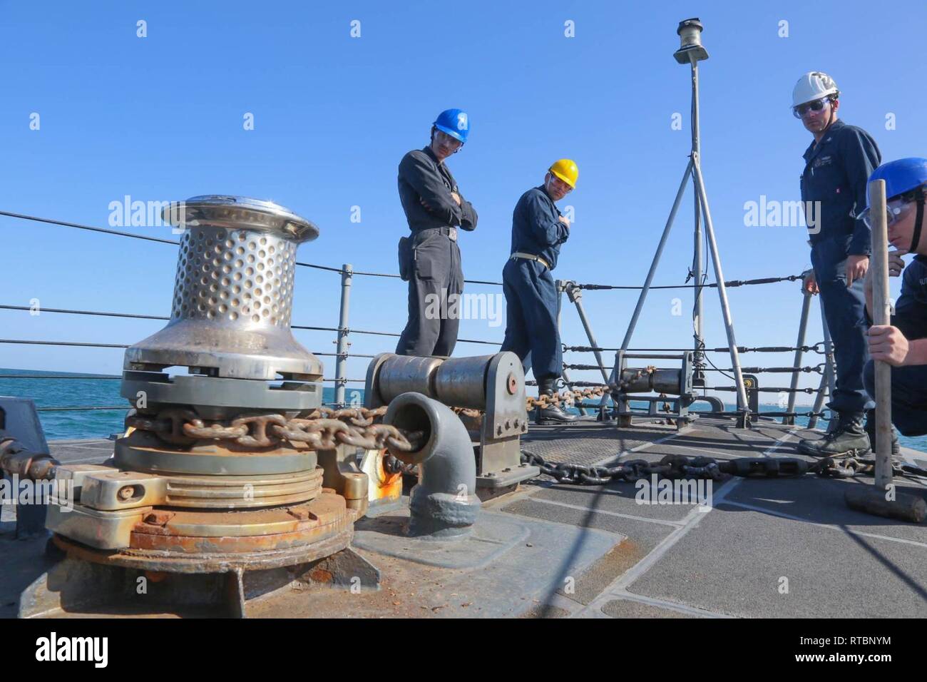 ARABIAN GULF (Feb. 9, 2019) Sailors observe the anchor chain lowering aboard the Cyclone-class coastal patrol ship USS Thunderbolt (PC 12). Thunderbolt is forward deployed to the U.S. 5th Fleet area of operations in support of naval operations to ensure maritime stability and security in the Central region, connecting the Mediterranean and the Pacific through the western Indian Ocean and three strategic choke points. Stock Photo