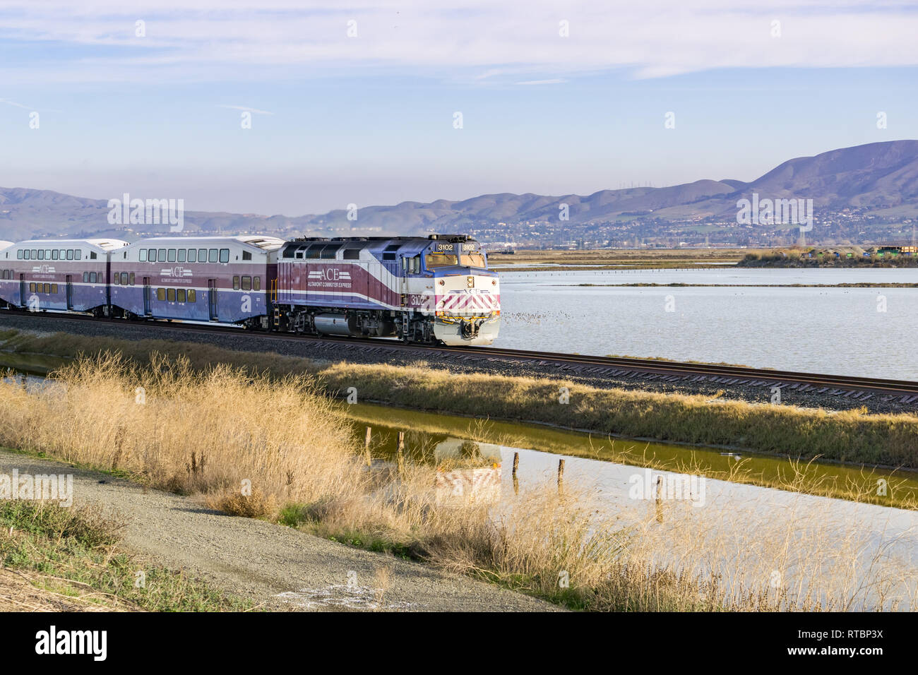 December 6, 2016, Altamont commuter express - Ace, San Jose, California, USA - Train passes through Alviso marsh on a sunny morning Stock Photo