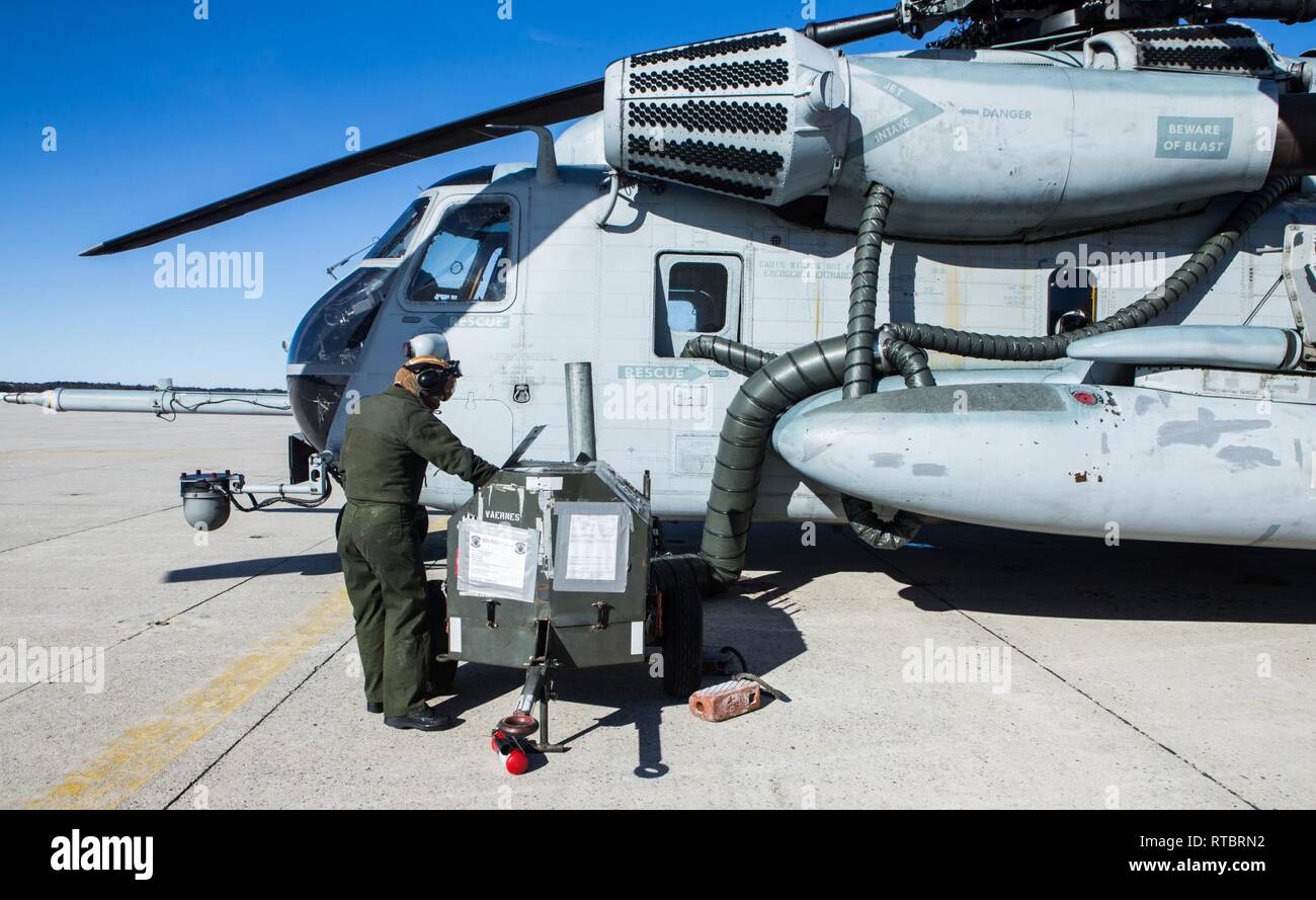 U.S. Marine Lance Cpl. Kaylee R. Cason operates a preheater to warm CH-53E Super Stallion engines in Brunswick, Maine, Feb. 11, 2019. Marine Heavy Helicopter Squadron (HMH) 464 is participating in a cold weather training exercise. Executing this training ensures that HMH-464 is prepared to support the Marine Air-Ground Task Force (MAGTF) commander during all phases of expeditionary operations Cason is a flight line mechanic assigned to HMH-464, Marine Aircraft Group 29, 2nd Marine Aircraft Wing. Stock Photo
