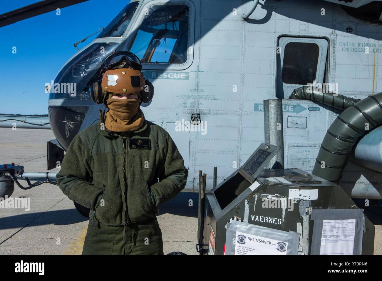 U.S. Marine Lance Cpl. Kaylee R. Cason operates a preheater to warm CH-53E Super Stallion engines in Brunswick, Maine, Feb. 11, 2019. HMH-464 is participating in a cold weather training exercise in Brunswick, Maine. Executing this training ensures that HMH-464 is prepared to support the Marine Air-Ground Task Force (MAGTF) commander during all phases of expeditionary operations. Cason is a flight line mechanic assigned to HMH-464, Marine Aircraft Group 29, 2nd Marine Aircraft Wing. Stock Photo