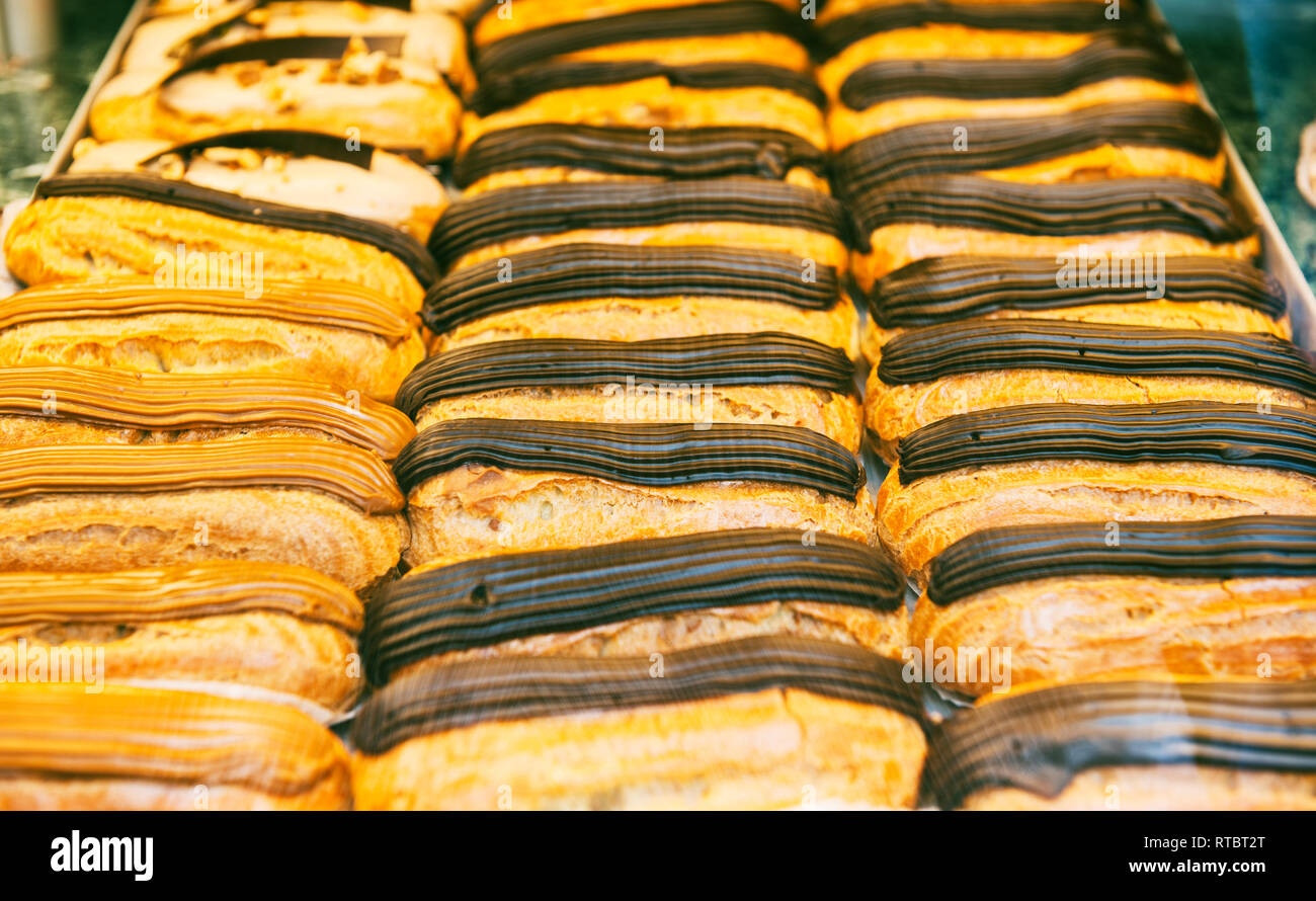 Traditional french eclairs sweets in French bakery store window