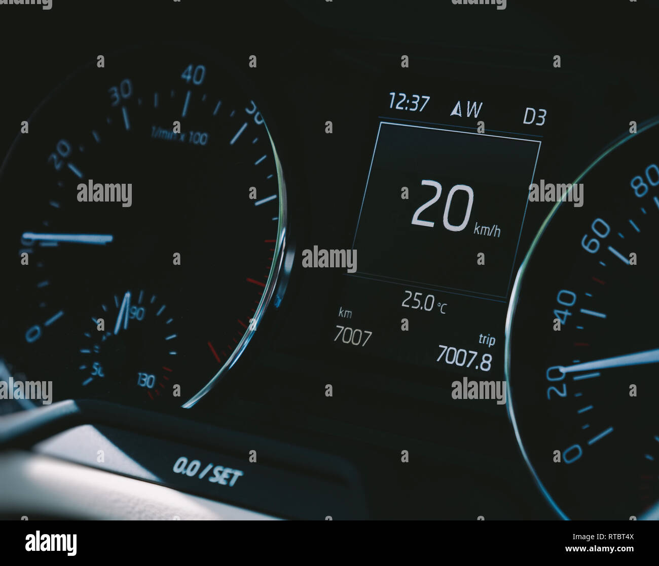 Car speedometer closeup with the needle pointing a 20 km/mph speed