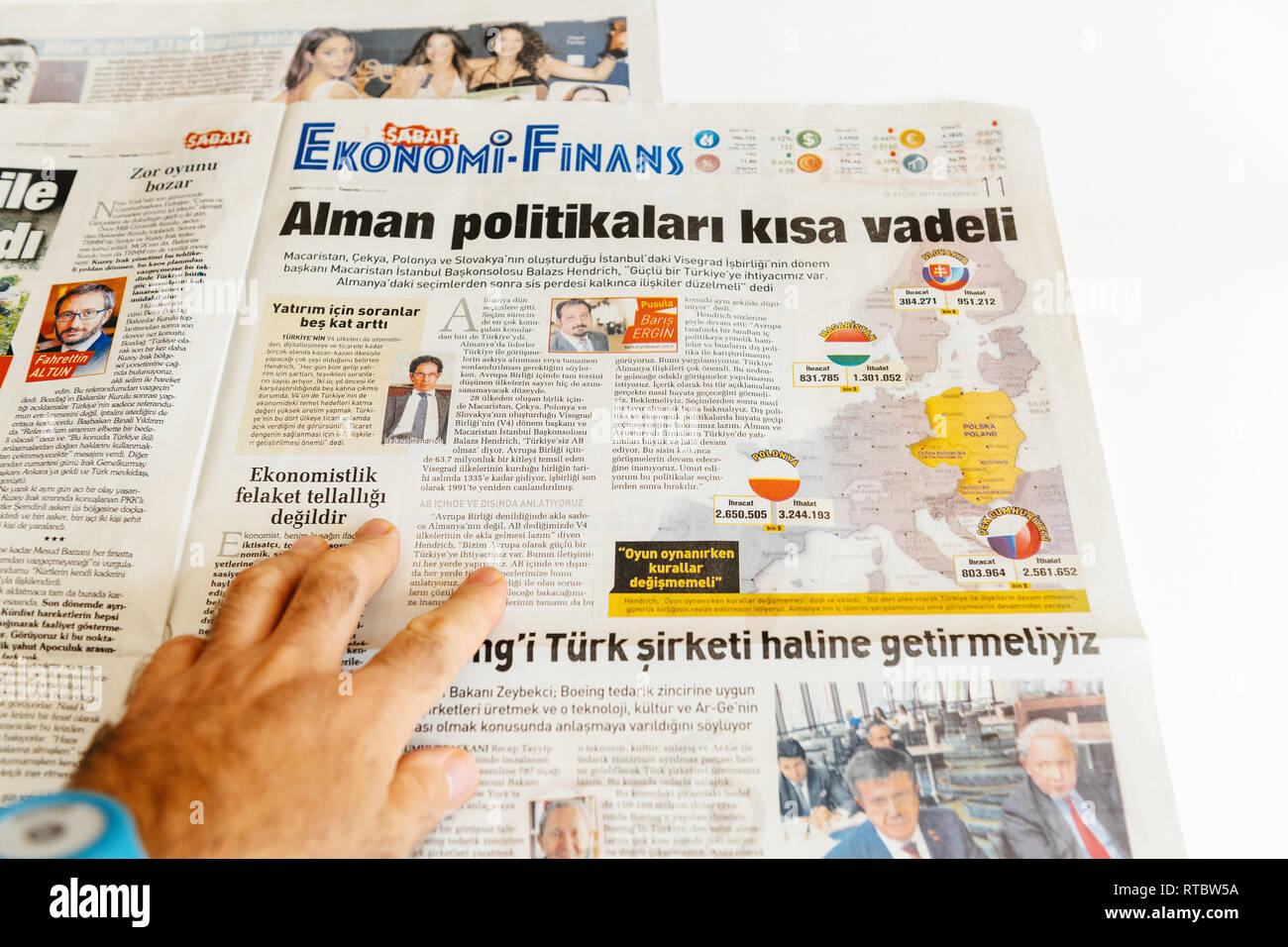 PARIS, FRANCE - SEP 25, 2017: Man reading Turkish Sabah newspaper about politics in Poland, Hungary, Slovakia and Czech Republic Stock Photo