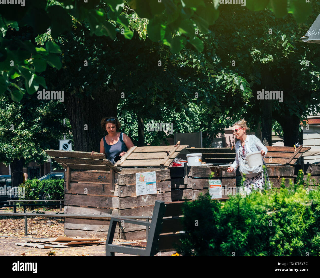 PARIS, FRANCE JUN 24 2017 Adult women composting in urban environment in dedicated spaces in