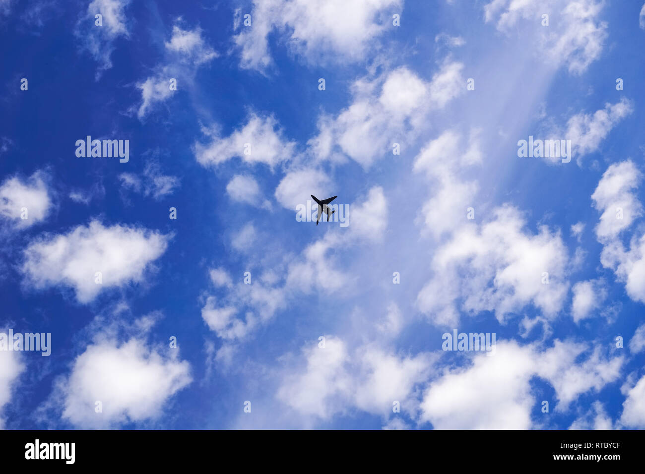Airplane flying on a cloudy sky background Stock Photo - Alamy